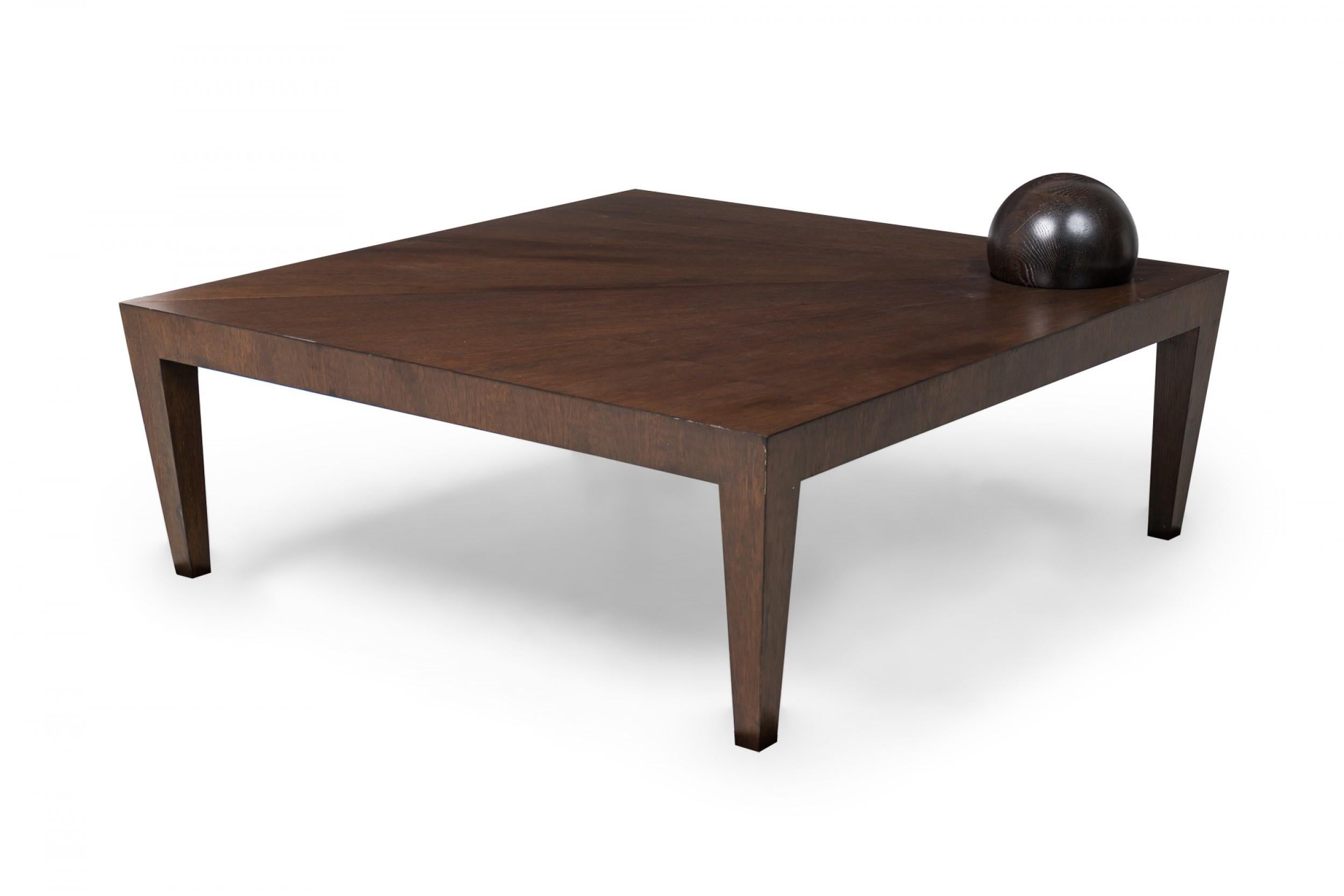 Contemporary American square coffee table with fitted and removable orb, resting on 4 tapered block legs (ANTONIO FORTUNA)

The orb is slightly darker