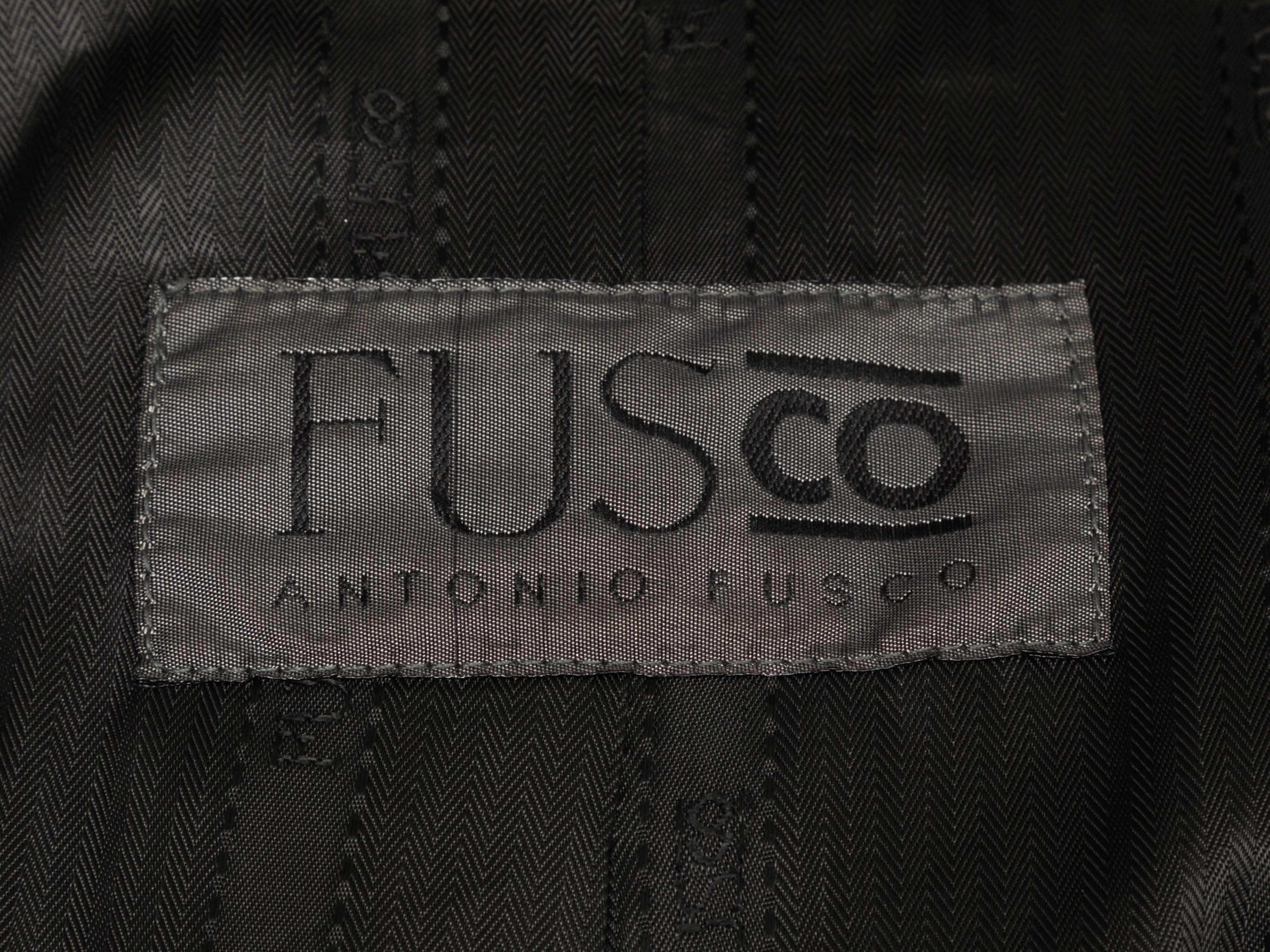 Product Details: Black long faux Persian lamb fur coat by Antonio Fusco. Notched lapel. Sash tie at waist. Button closures at center front. 38