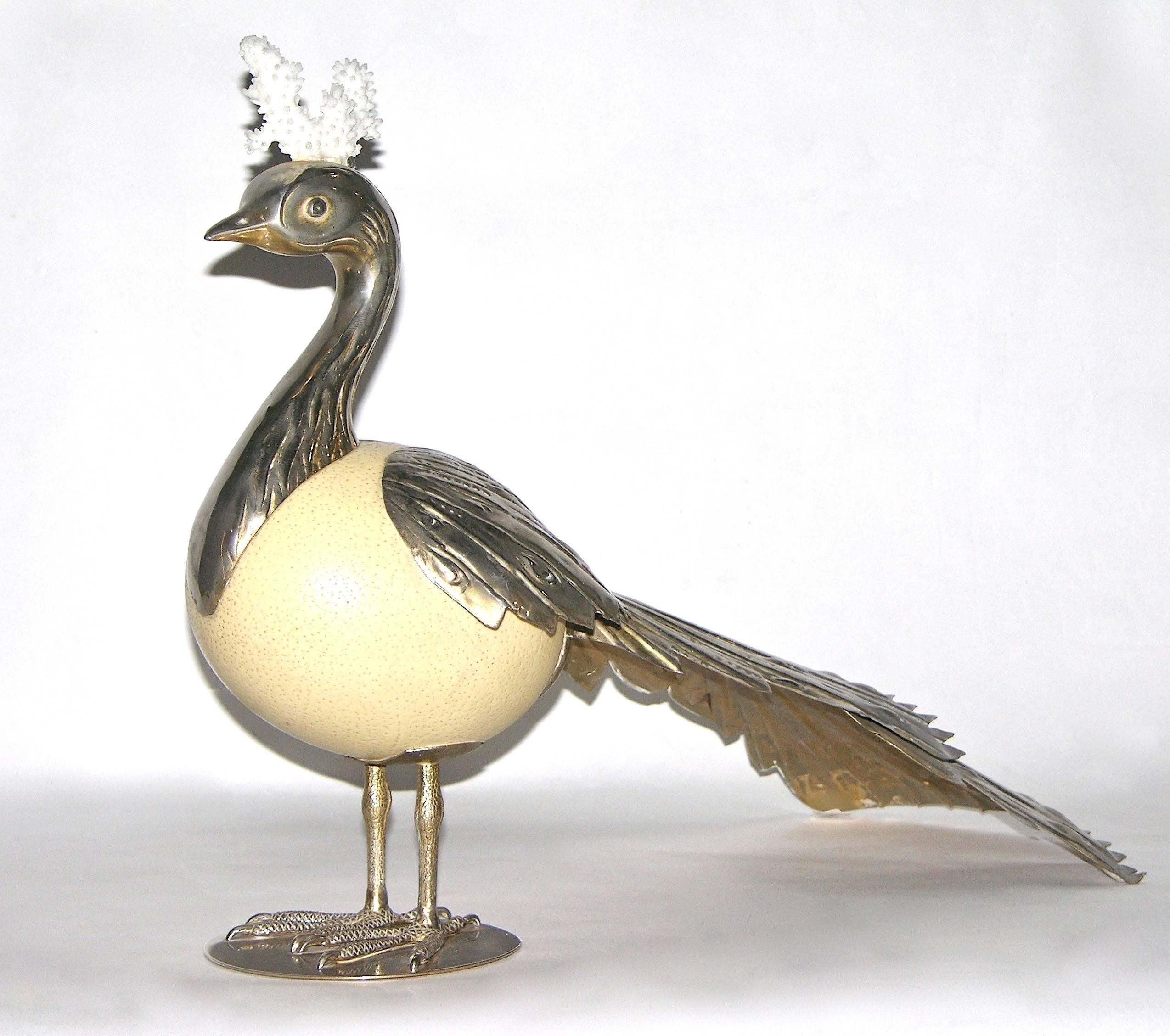 This one-of-a-kind Italian Work of Art, a sculpture bird by Antonio Pavia, is a rare highly collectible object, entirely handcrafted, with an ostrich egg as the body, decorated with an impressive chased silver plated long feathered tail and topped