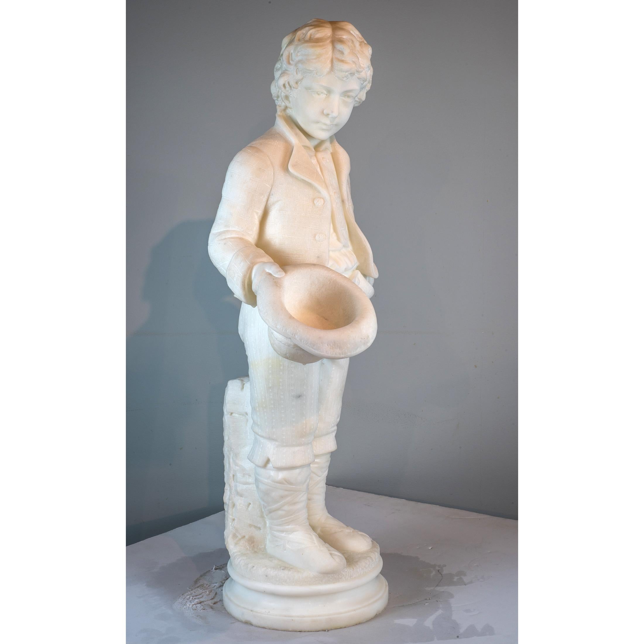 Italian marble figure of a boy carrying a hat, standing on a round plinth with a log behind, signed 'A. Piazza Carrara' 

Artist: Antonio Piazza (Late 19th-Early 20th Century)
Date: Late 19th century
Origin: Italian
Dimension: 33 1/2 x 14 in. x