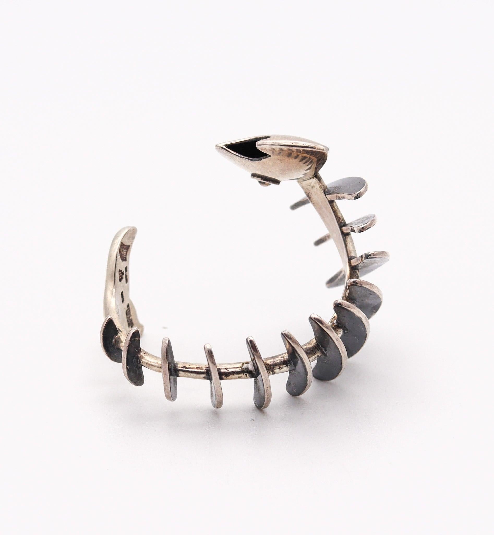 Sculptural fish cuff-bracelet designed by Antonio Pineda (1919-2009).

This is an exceptional and highly collectible vintage cuff-bracelet, created in Taxco Mexico by the renowned silversmith Antonio Pineda, back in the 1953. The iconic sculptural