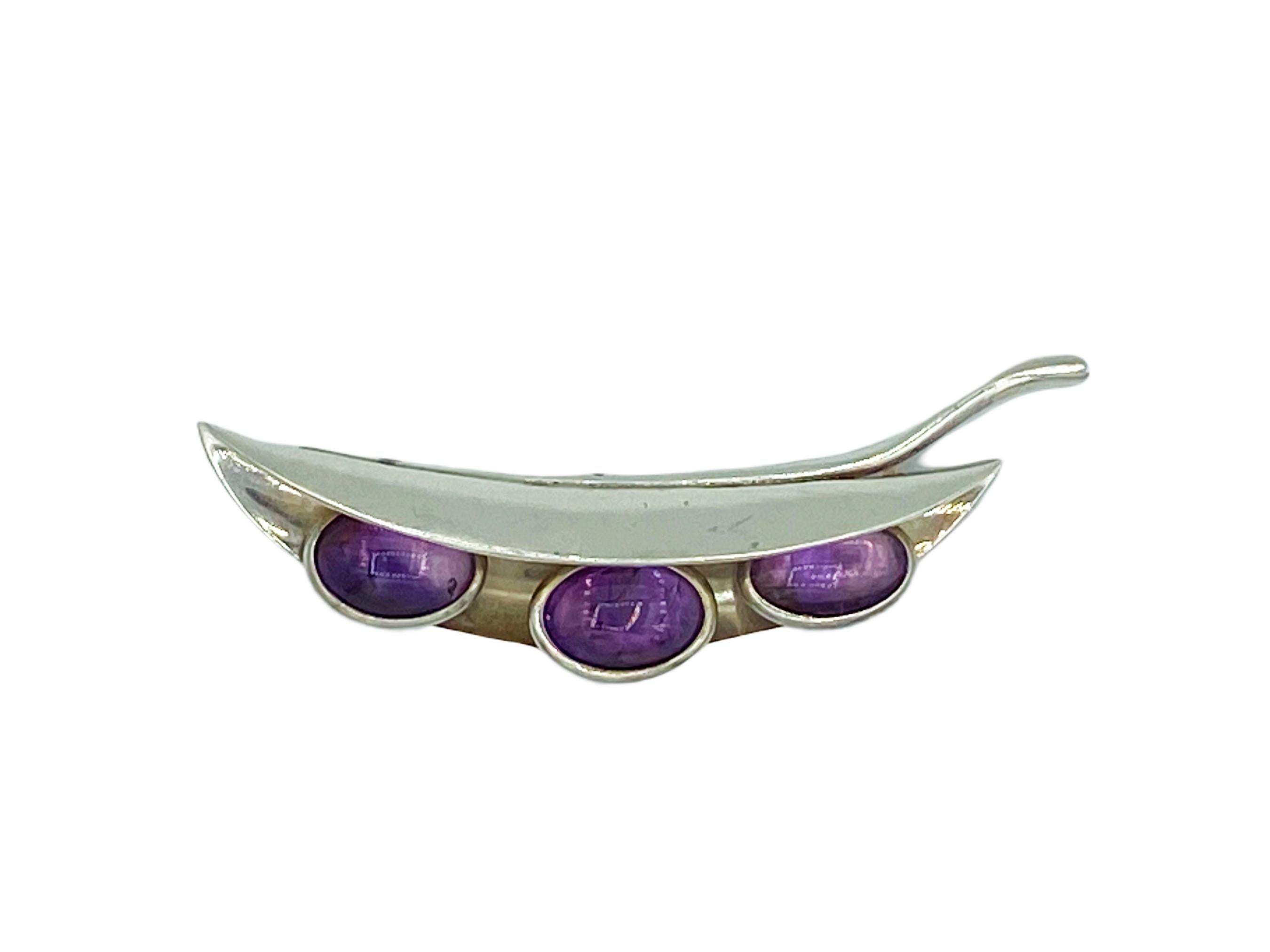 Absolutely stunning, avante garde work of wearable art by Taxco, Mexico master silversmith Antonio Pineda! In top quality 970 purity silver, this circa 1960s brooch is in the whimsical form of amethyst cabochon peas set in a silver pod. An amazing