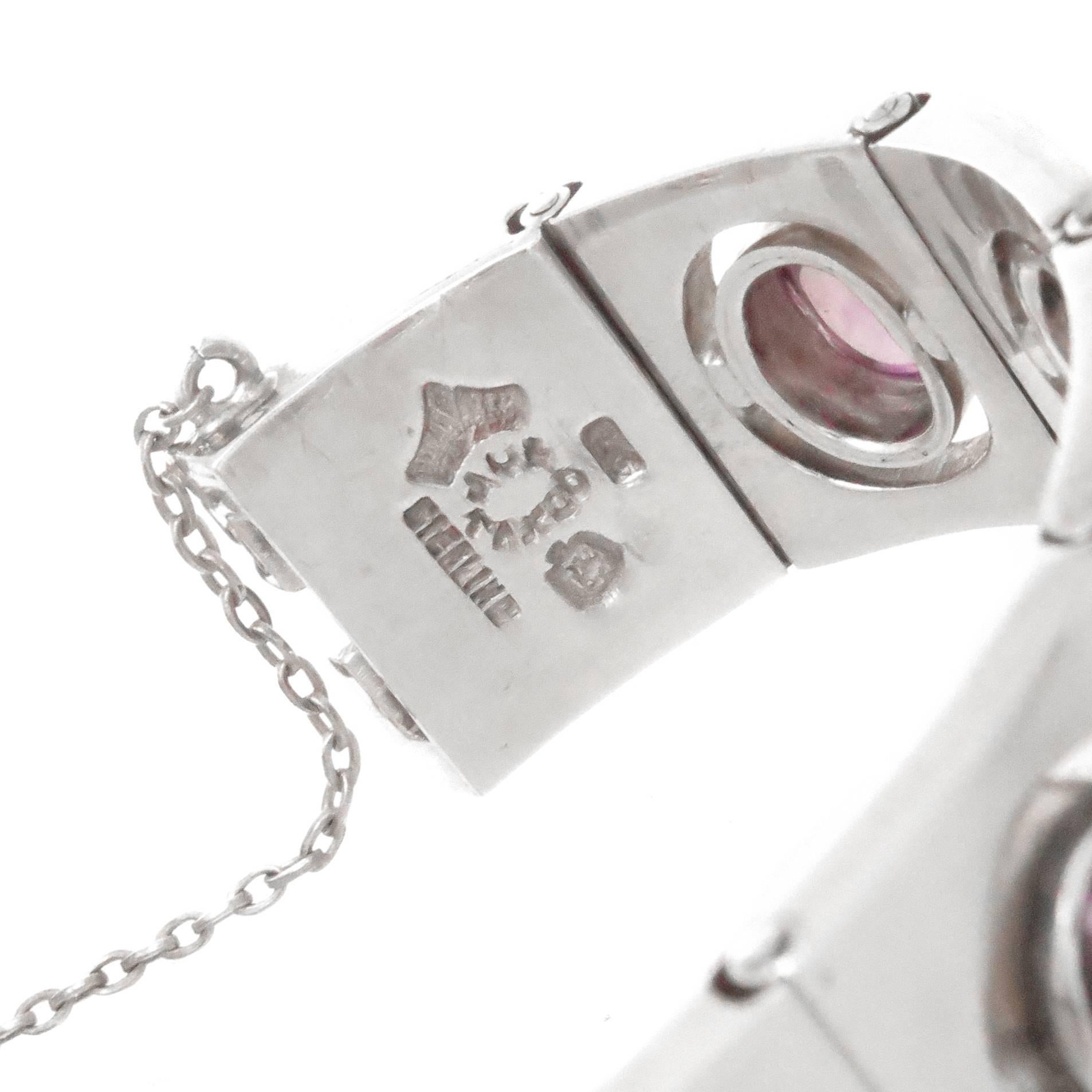 Circa 1960 Antonio Pineda Sterling Silver Bracelet, measuring 3/4 inch wide and consisting of solid, heavy individually riveted and articulated link sections each set with a domed oval Cabochon Amethyst. Bracelet length 6 3/4 inches.  
