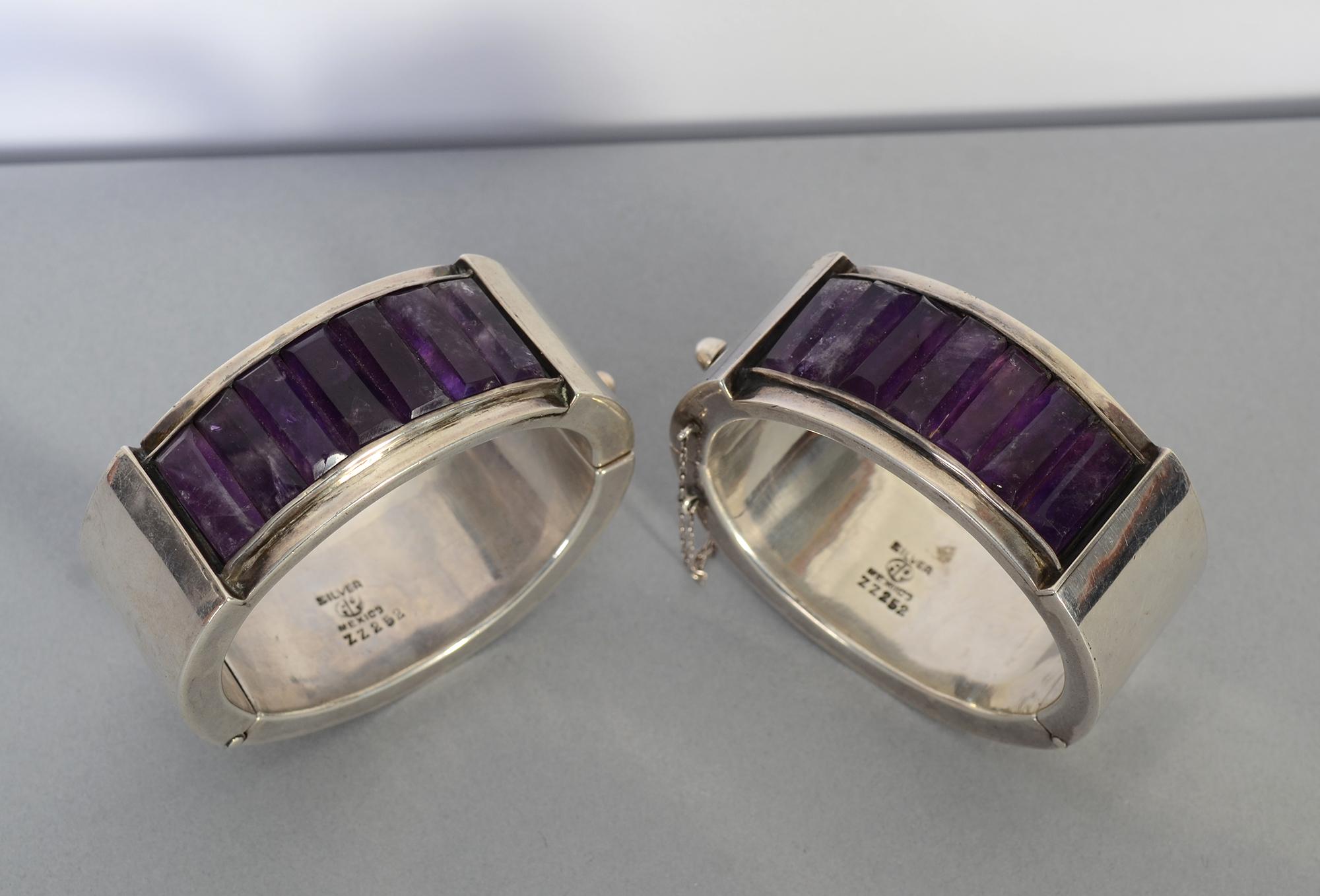 
This is a stunning and unusual pair of early Antonio Pineda bangle bracelets made of sterling silver and amethyst. Both bracelets have Antonio's mark used between 1941 and 1949. They measures 1 3/16
