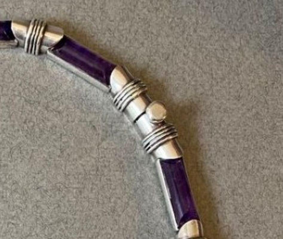 Antonio Pineda Sterling Silver and Amethyst Necklace.

Each of cylindrical links of amethyst alternating with ribbed silver segments. Matching bracelets available.

Good condition with tarnishing and light scratches commensurate with age. Amethysts