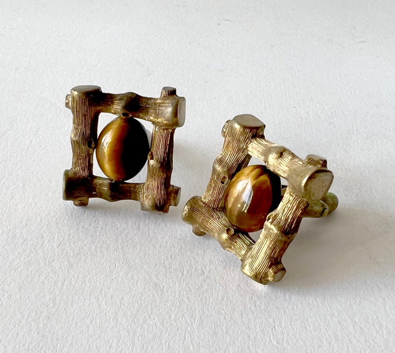 Sterling cufflinks with gold vermeil overlay and fiery tiger eye cabochon gemstones created by Antonio Pineda of Taxco, Mexico.  Vermeil adds a deepened golden bronze like tone to the metal.  Cufflinks measure 7/8