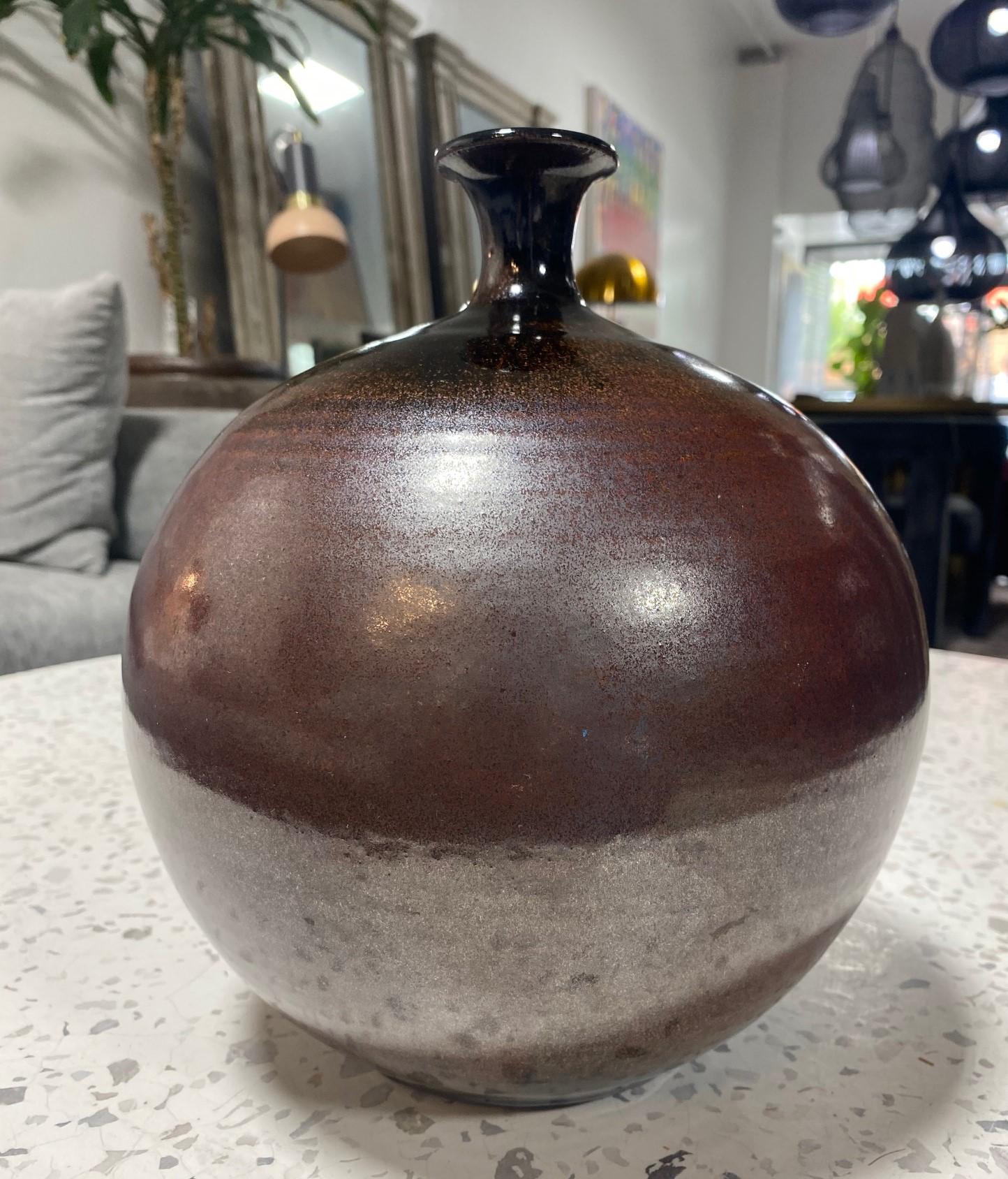 A beautifully shaped, relatively large, and sumptuously glazed Mid-Century Modern California Studio pottery vase by Spanish American master potter Antonio Prieto.  The work features a gorgeous plum-purple glaze with hints of browns and reds.  It is