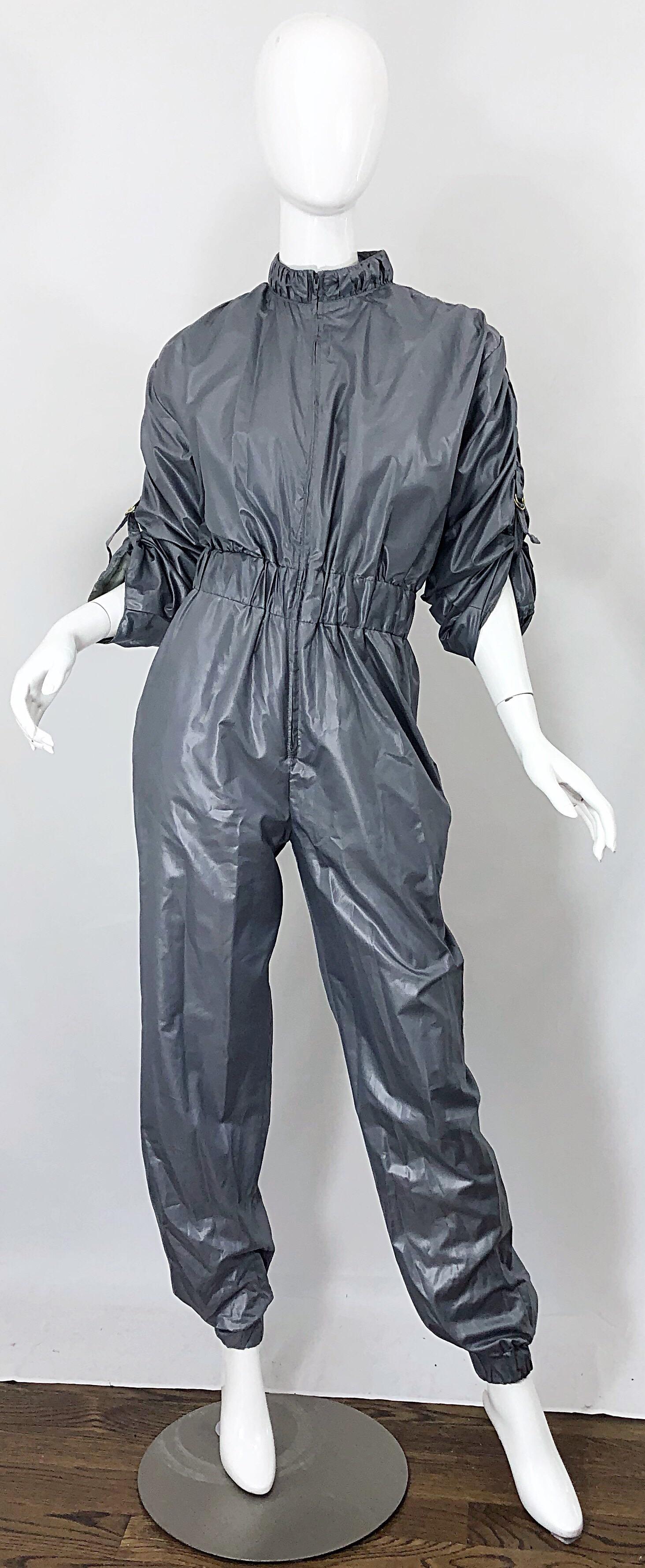Avant Garde ANTONIO RUSPOLI, by JOY STEVENS shark gray one piece jumpsuit! Features a zipper up the front, which can be worn fully zipped, or left open to reveal cleavage. Adjustable ruched sleeves can be adjusted with attached buckle. Elastic