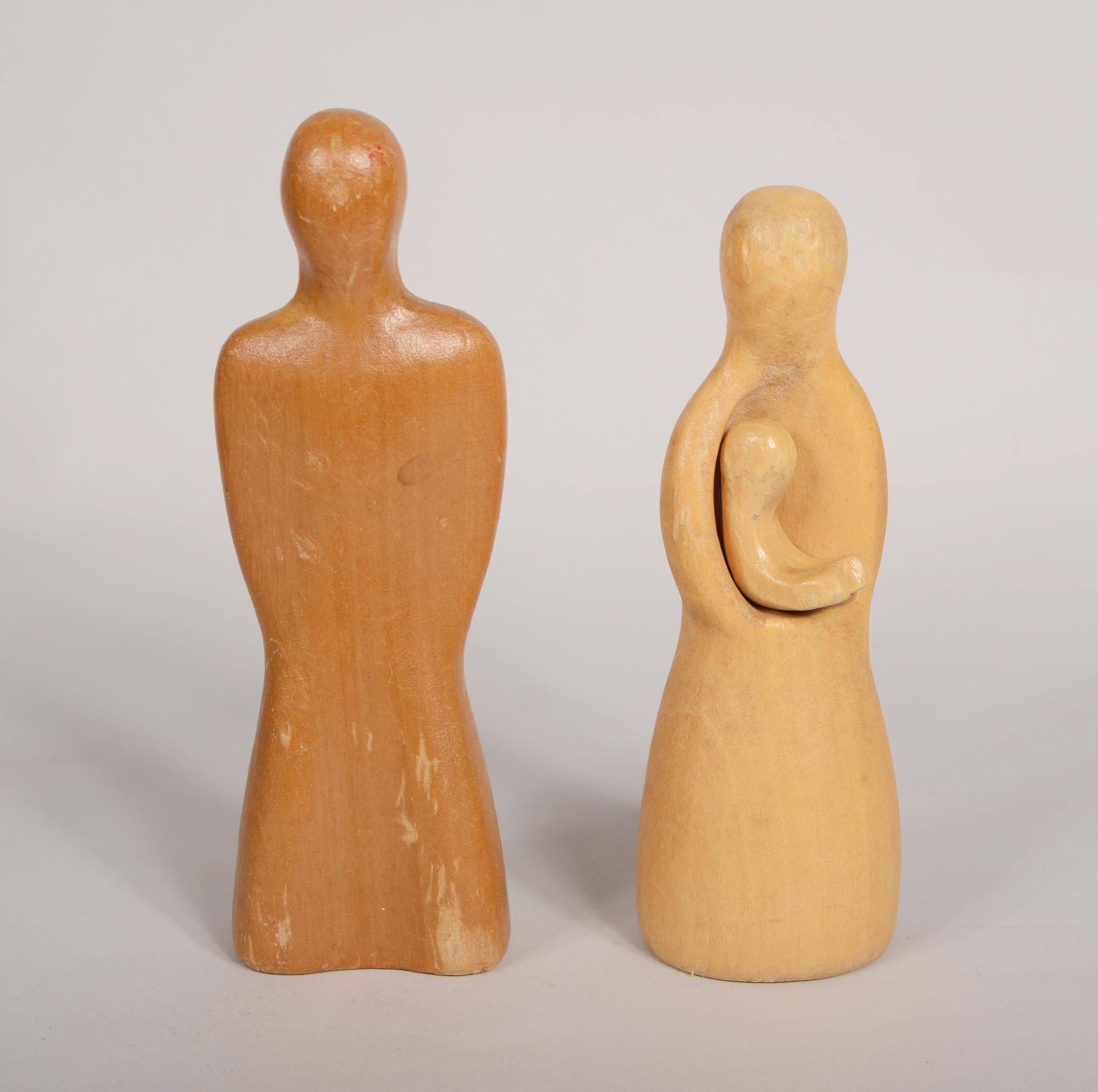 Carved wood toy family by Antonio Vitali, Swiss toy designer. Vitali designed this set for Creative Playthings in 1954. These were marketed under the name Playforms. The set includes a father, a mother holding a baby, boy, girl, cat and dog. These