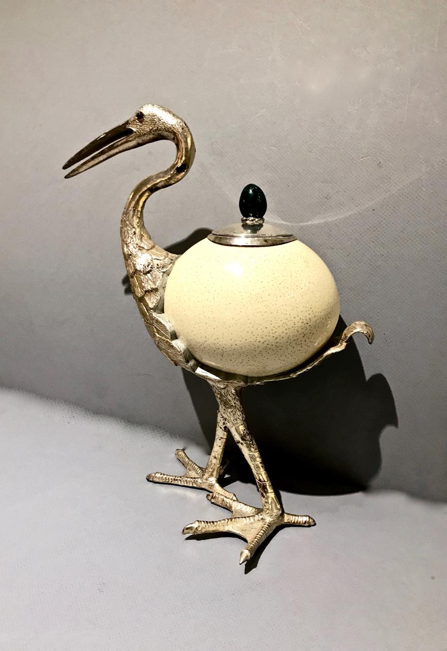 This is an outstanding example of an Antony Redmile decorative element that employs a naturalistic form to express the peak of decorative design. The Heron features a small silver plated covered recess whose lid is topped with a cabochon malachite