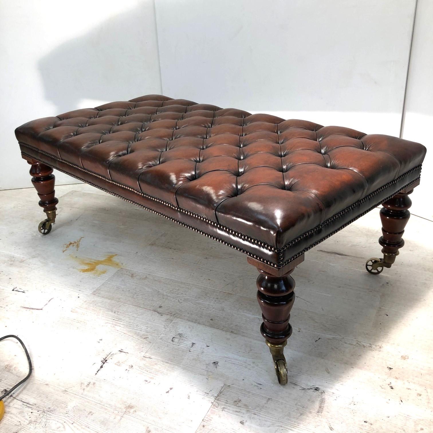 We are delighted to offer for sale this very large, fully restored, hand dyed brown leather Chesterfield hearth stool ottoman with oversized wagon wheel castors 

A very good looking well made and decorative hearth stool, this sat between two