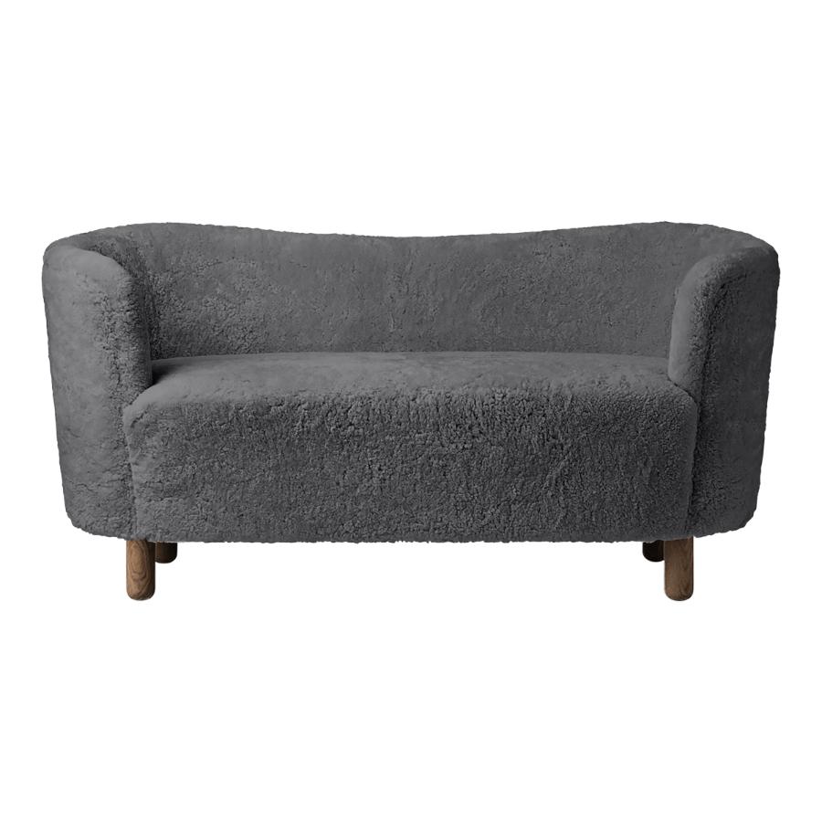 Antrachite sheepskin and smoked oak mingle sofa by Lassen.
Dimensions: W 154 x D 68 x H 74 cm. 
Materials: Sheepskin, oak.

The Mingle sofa was designed in 1935 by architect Flemming Lassen (1902-1984) and was presented at The Copenhagen