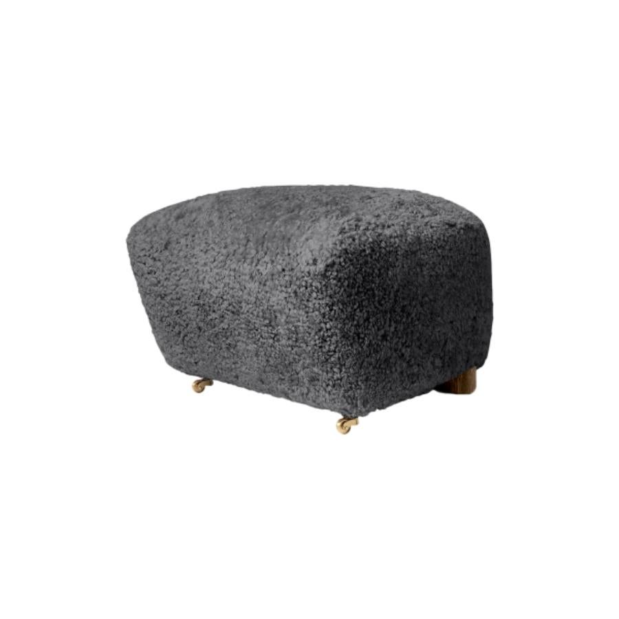 Antrachite smoked oak sheepskin the tired man footstool by Lassen
Dimensions: W 55 x D 53 x H 36 cm 
Materials: Sheepskin

Flemming Lassen designed the overstuffed easy chair, The Tired Man, for The Copenhagen Cabinetmakers’ Guild Competition in