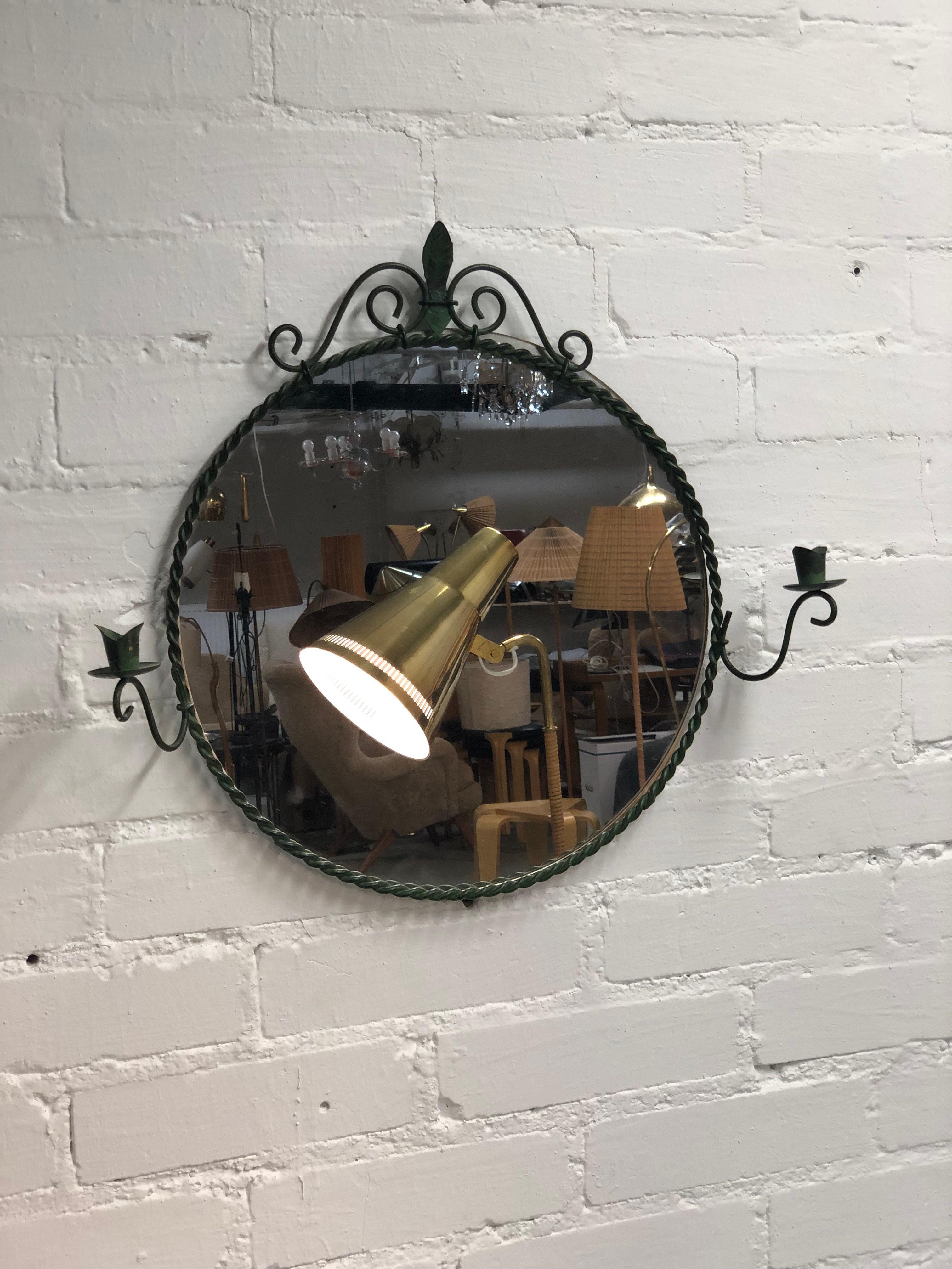 A beautiful wall mirror in solid iron designed by Antti Hakkarainen and manufactured by Taidetakomo Hakkarainen in the 1930s. The mirror is in great original condition with a beautiful greenish patina. Antti Hakkarainen was well known for his