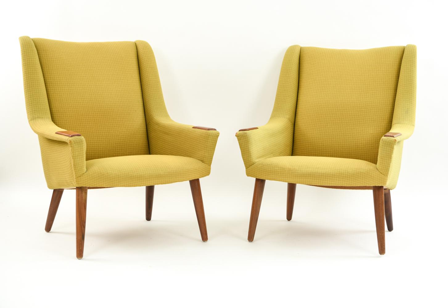 This Danish midcentury seating suite includes a blue upholstered sofa and two green upholstered lounge chairs. Featuring an attractive wood detail on the arms and modern angled legs, this suite epitomizes timeless Scandinavian midcentury design.