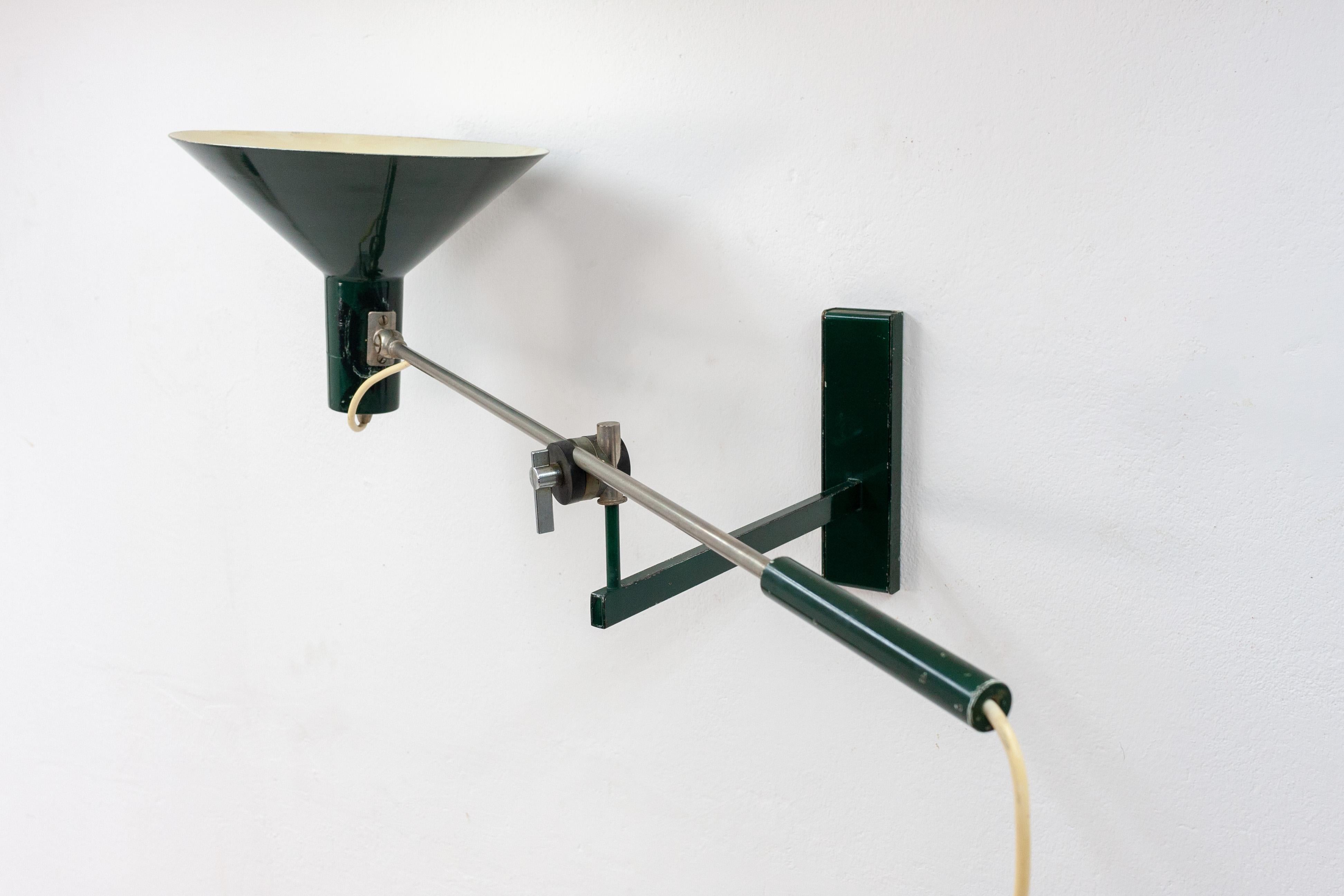 Very nice looking wall light designed by J.J .M .Hoogervorst for Anvia Holland in 1960. Finished in a great dark green color.