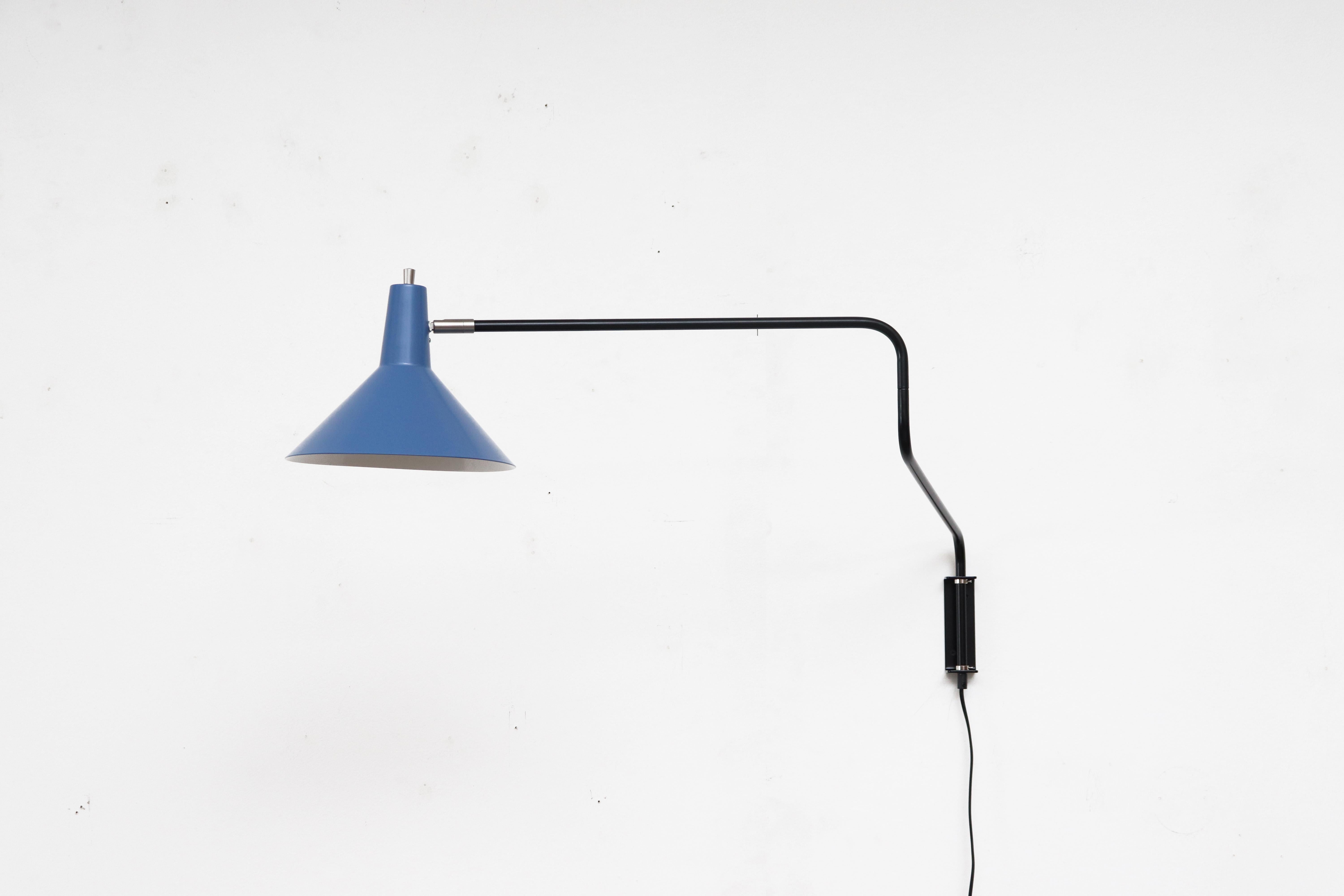 Newly re-issued Anvia 'The Paper Clip' wall lamp in blue with black frame. Has paper clip style arm that swings to extend or retract for versatile use and tilting/rotating shade. More colors available.