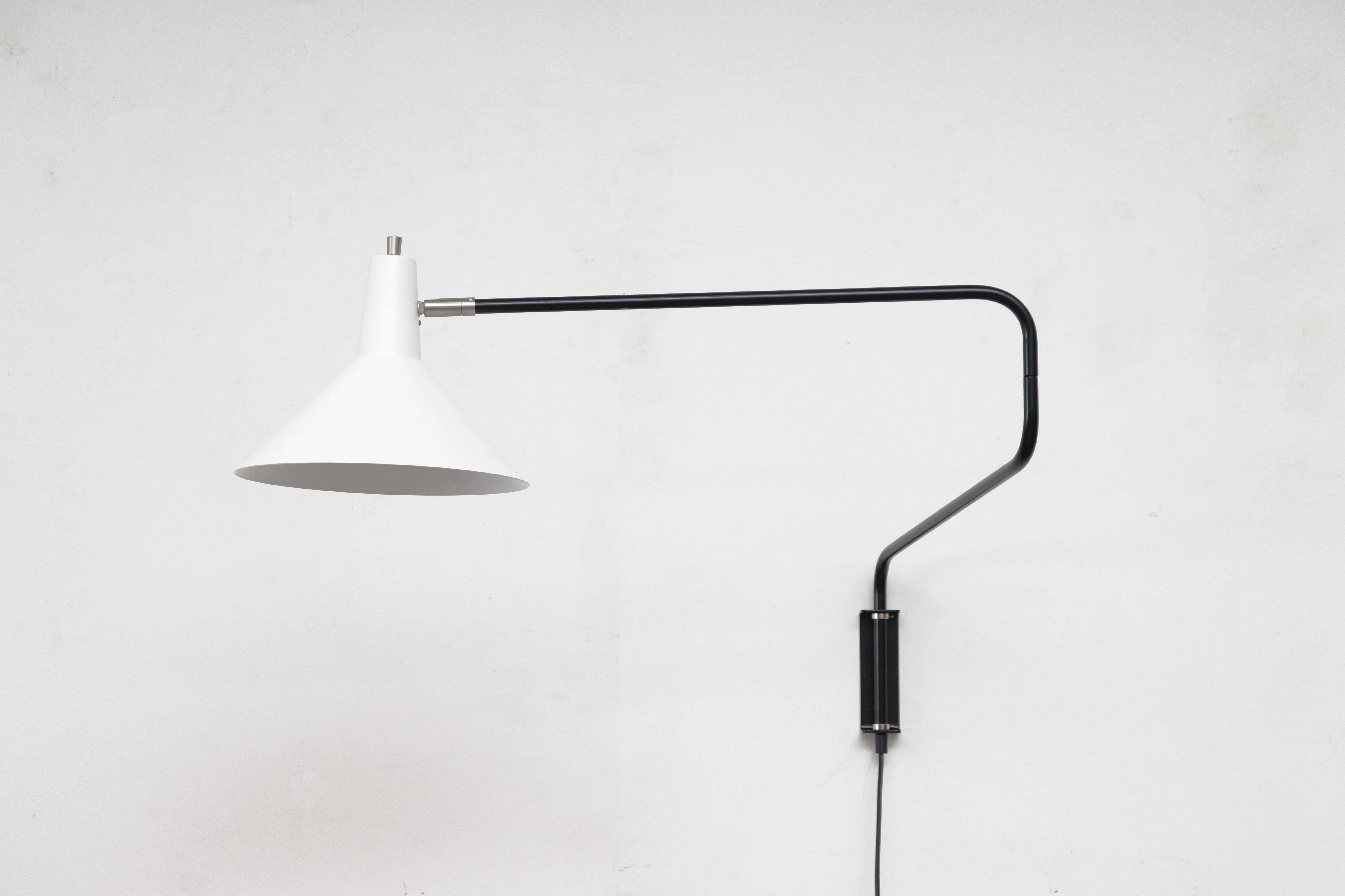 Newly re-issued Anvia 'The Paper Clip' wall lamp in white with black frame. Has paper clip style arm that swings to extend or retract for versatile use and tilting/rotating shade.