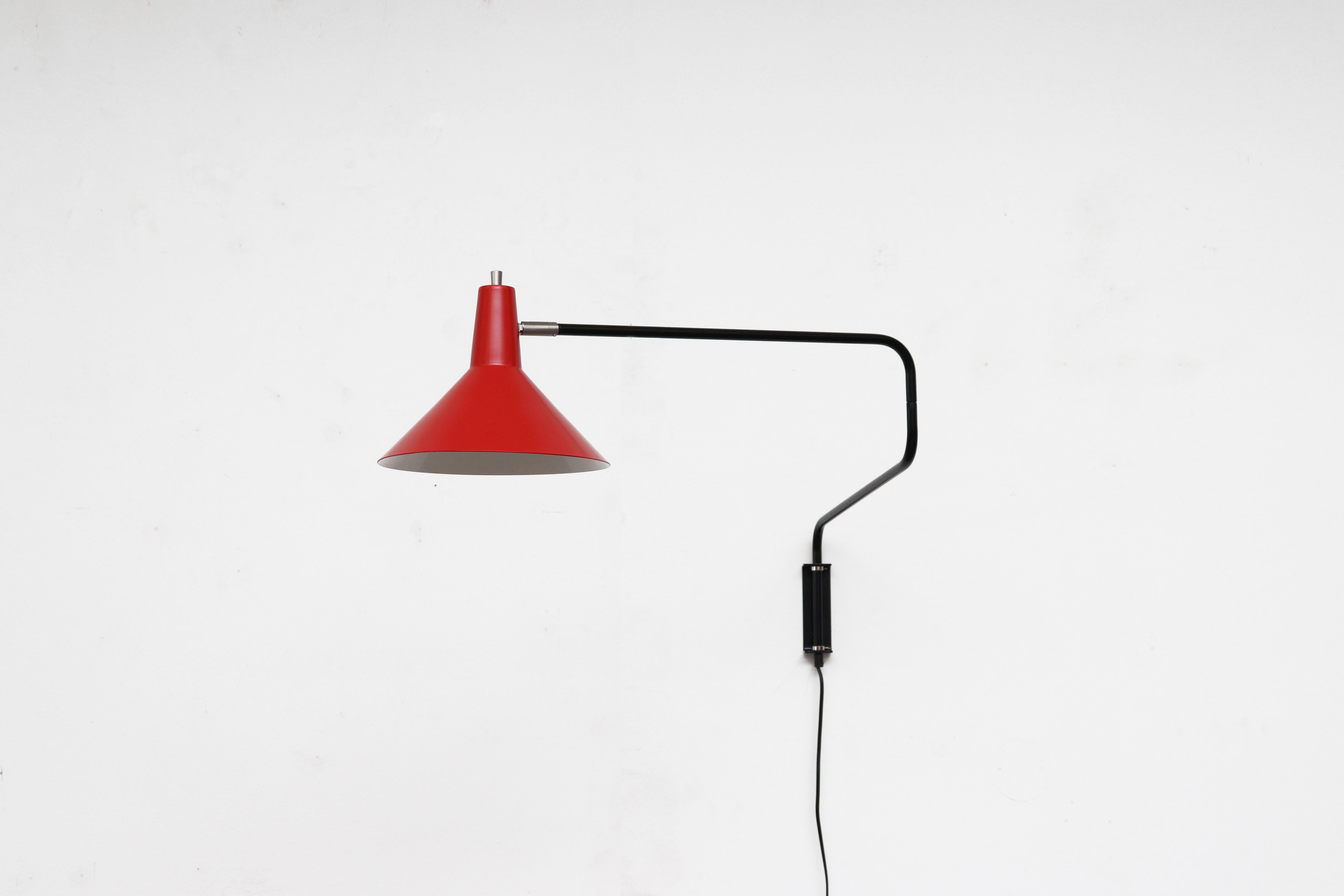 Newly re-issued Anvia 'The Paper Clip' wall lamp in red with black frame. Has paper clip style arm that swings to extend or retract for versatile use and tilting/rotating shade. More colors available, listed separately.