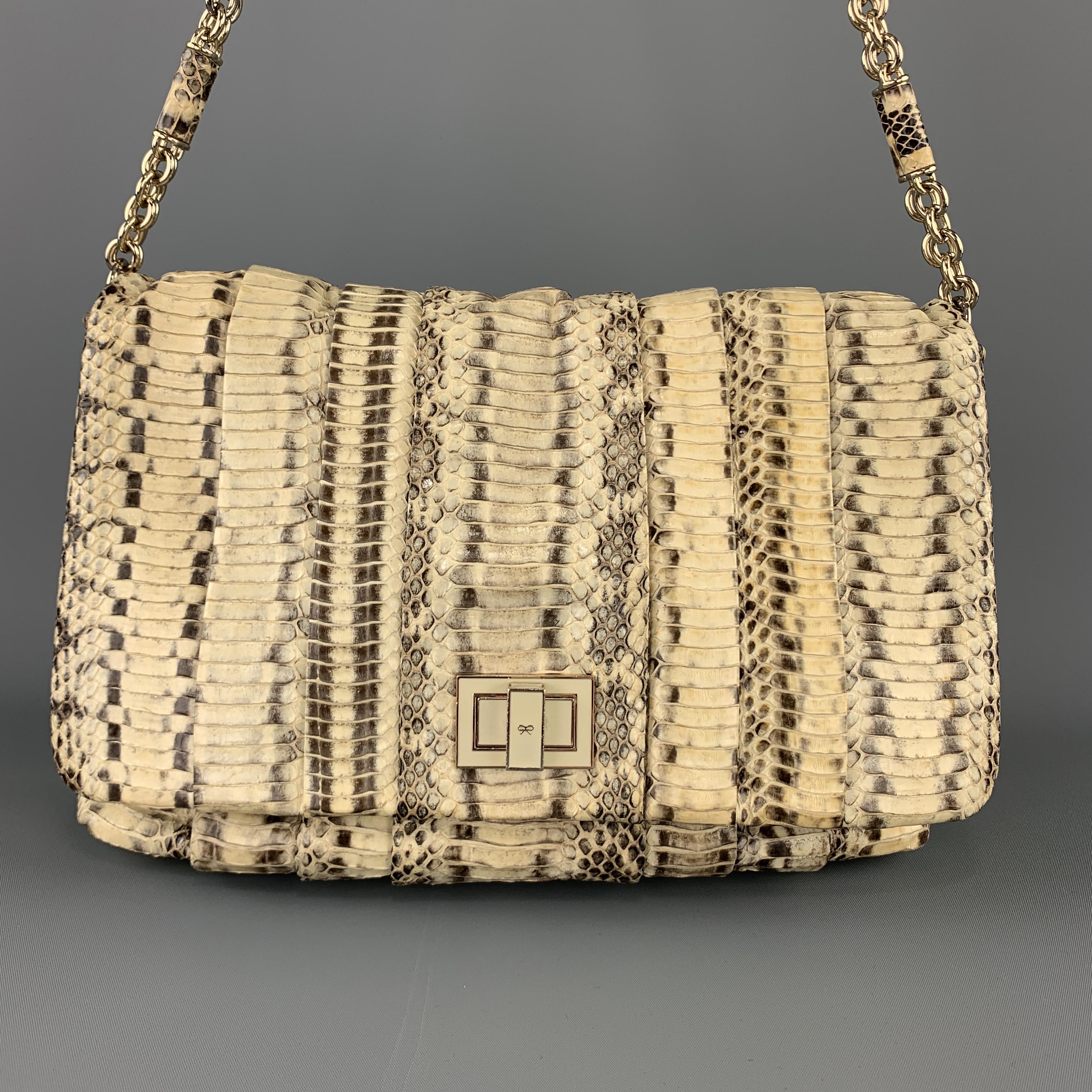 ANYA HINDMARCH shoulder bag comes in natural beige python skin leather with a pleated top flap, cream enamel turn lock closure, chain strap with leather links, and suede interior. Minor wear on liner.

Very Good Pre-Owned