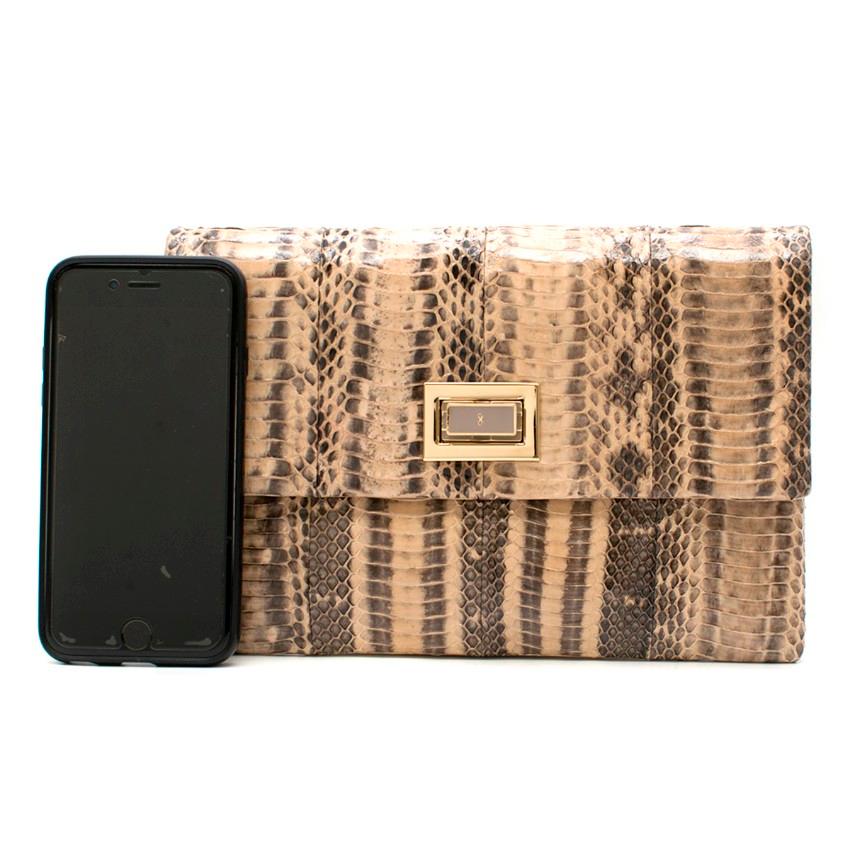 Anya Hindmarch Beige Python Valorie Clutch Bag.

- Snakeskin
- Internal pouch pocket
- Gold hardware
- Lined in beige suede and nude leather
- Designer-stamped twist lock fastening

Approx:
16cm x 23cm

ONESIZE