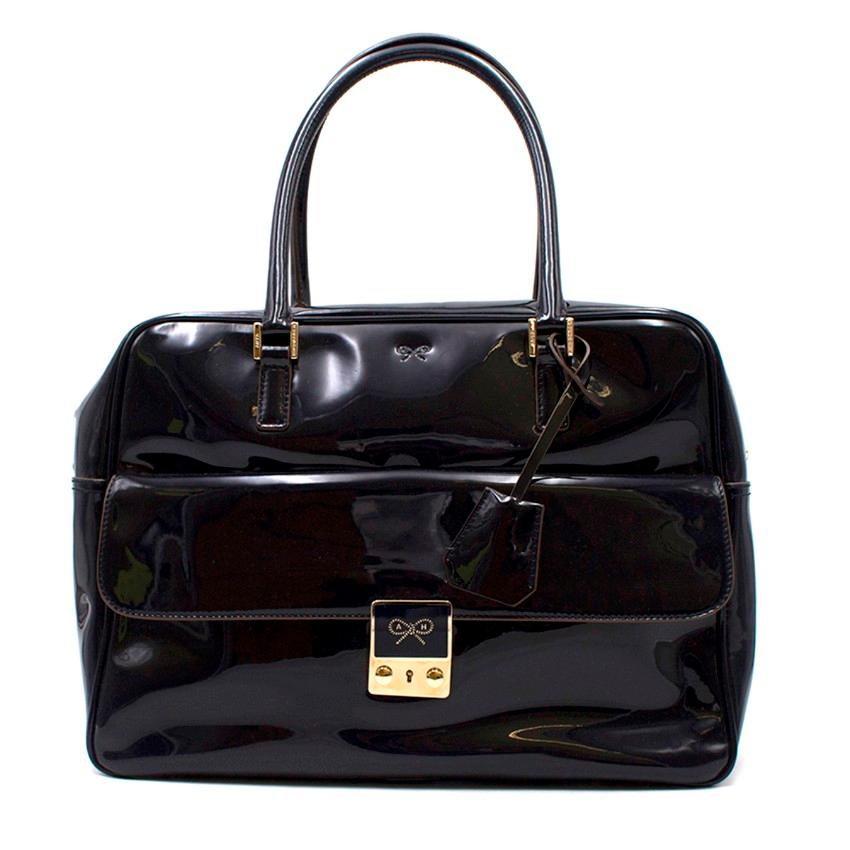 Anya Hindmarch Black Laminated Carker Bag

-Black top handle bag
-Gold toned hardware
-One front pocket with pinch clasp closure
-One main interior pocket with zip closure
-One interior zipped pocket, two slots and a key holder
-Bag comes with