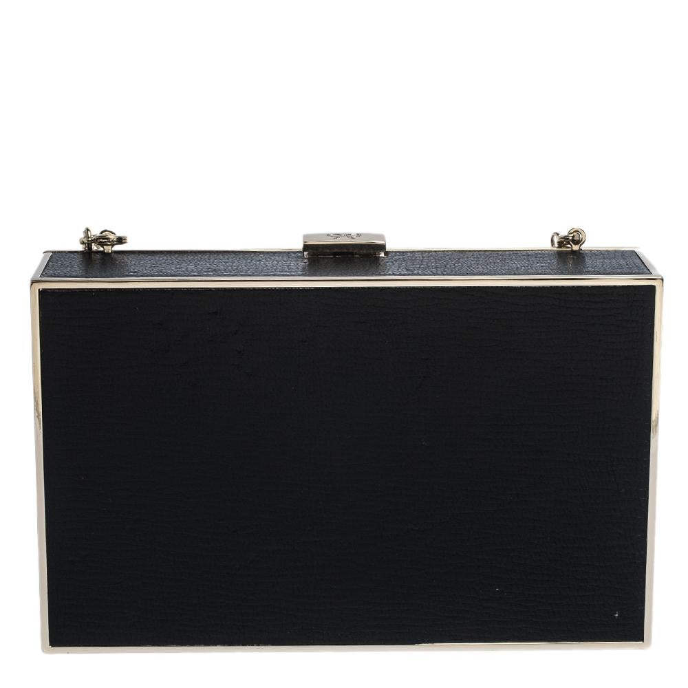 A creation from the house of Anya Hindmarch for the fashionable you! Crafted from leather into a box, this clutch features eye detailing on the front, a suede-lined interior and a chain. This clutch offers style and utmost practicality.

Includes: