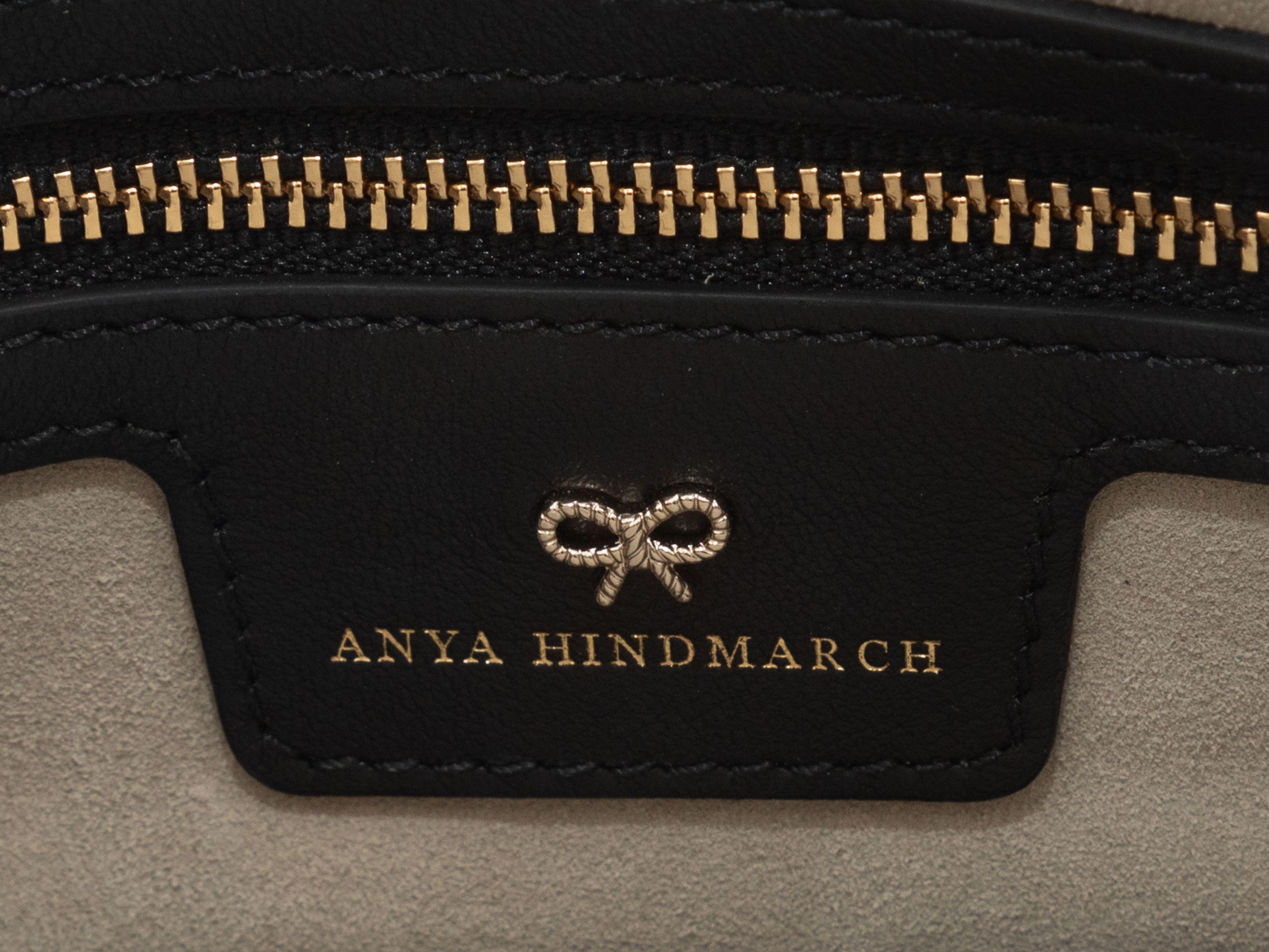 Product Details: Black & Multicolor Anya Hindmarch Allover Sticker Print Clutch. This clutch features an embossed leather body, gold-tone hardware, interior zip pocket, interior card slots, and a tassel-accented zip closure at the top. 11