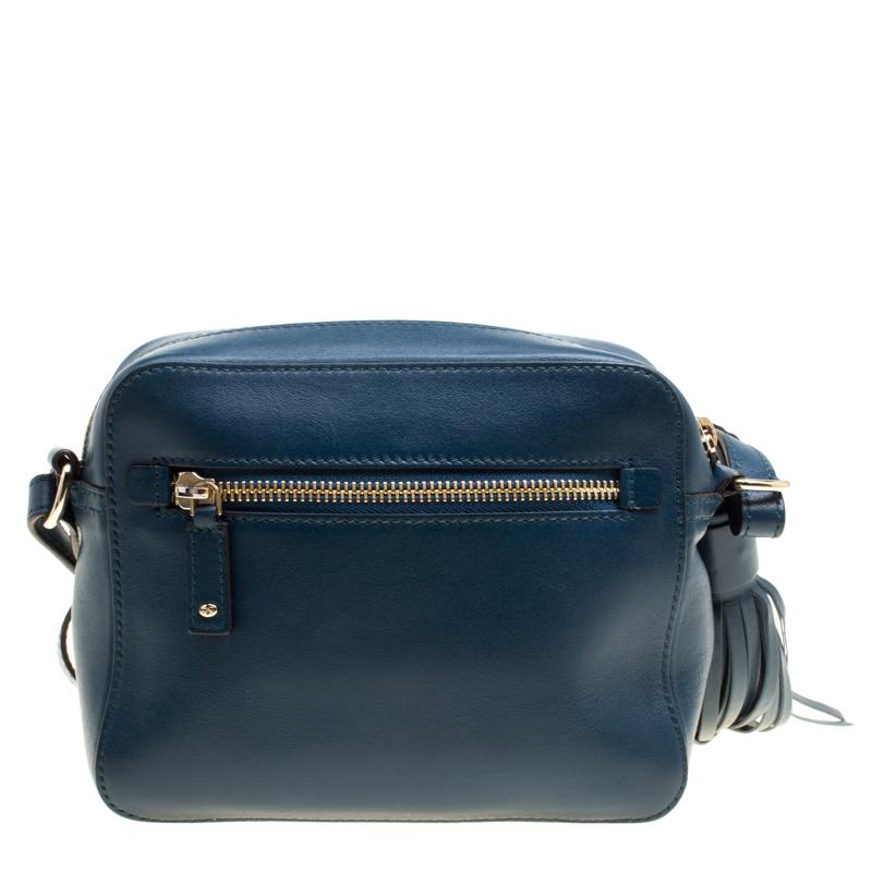 This pretty crossbody bag comes in a lovely blue leather body that flaunts gold-tone hardware. The top zip closure detailed with a tassel encloses a suede-lined interior featuring leather card slots. The front body is embellished with a perforated