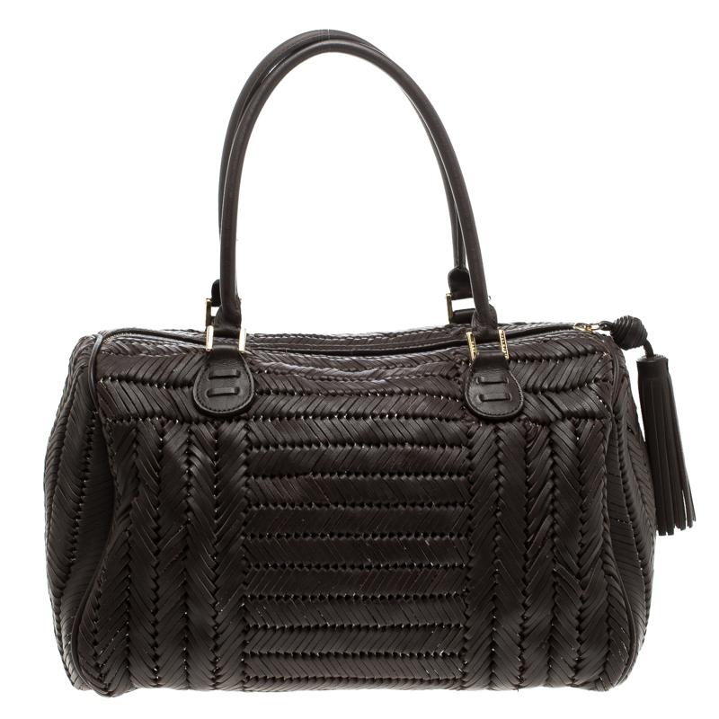 This braided leather tote by Anya Hindmarch is an elegant and stylish bag. Accentuated with gold tone hardware and tassel trinket, it makes a perfect pick to store your daily necessities. This Sydney styled satchel has dual handles and protective