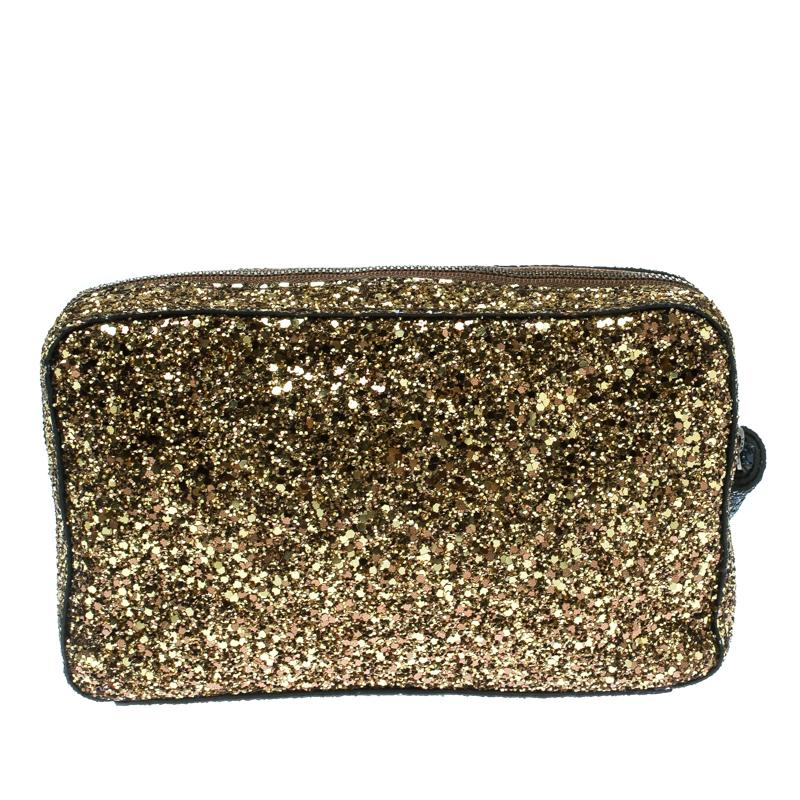 Carry your essentials in style with this Twinkle clutch from Anya Hindmarch. Crafted from coated fabric and glitter the clutch has a tassel zip pull that opens to a suede interior. The clutch will easily fit all your party essentials.

Includes: The