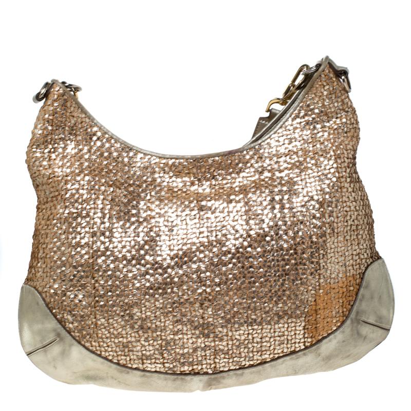 Anya Hindmarch's handbags are popular owing to their high style and eccentricity. This Jethro hobo is crafted from metallic gold woven leather and smooth trims and comes with a single shoulder strap and gold-tone hardware. It is complete with a top