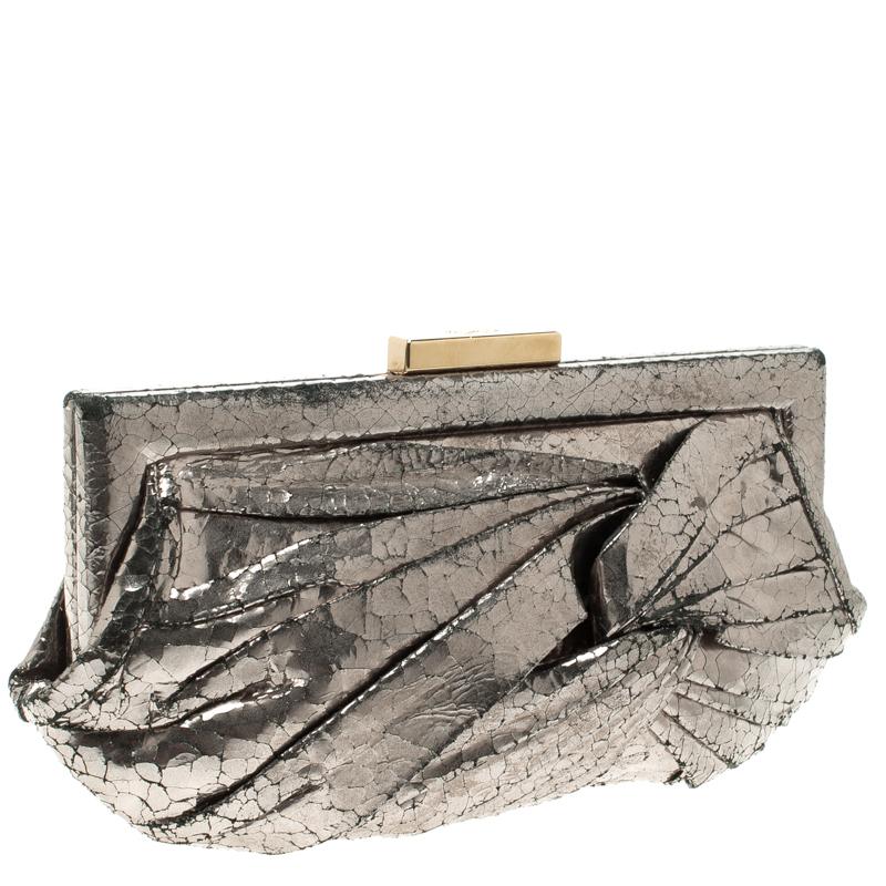 Wear it to parties or even with your more formal outfits, this beautiful Anya Hindmarch clutch will instantly add some bling to your outfit. Crafted in metallic silver leather, the surface is designed in a crackled texture along with pleated