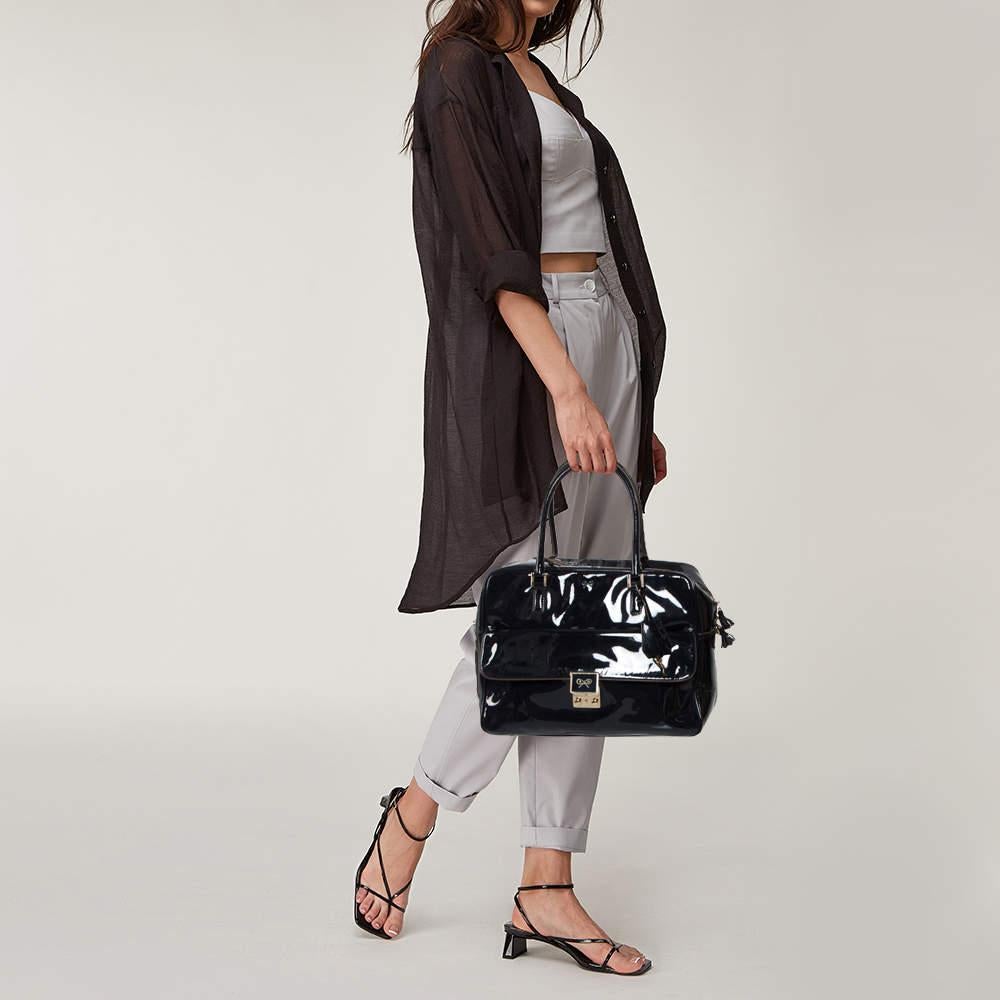 Simple yet classy, this satchel by Anya Hindmarch goes with a wide range of outfits. Designed with patent leather, the bag is equipped with a front pocket, a nylon interior, and two top handles. It's a fine choice for an everyday bag.