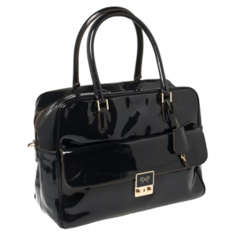 Simple yet classy, this satchel by Anya Hindmarch goes with a wide range of outfits. Designed with patent leather, the bag is equipped with a front pocket, a nylon interior, and two top handles. It's a fine choice for an everyday bag.