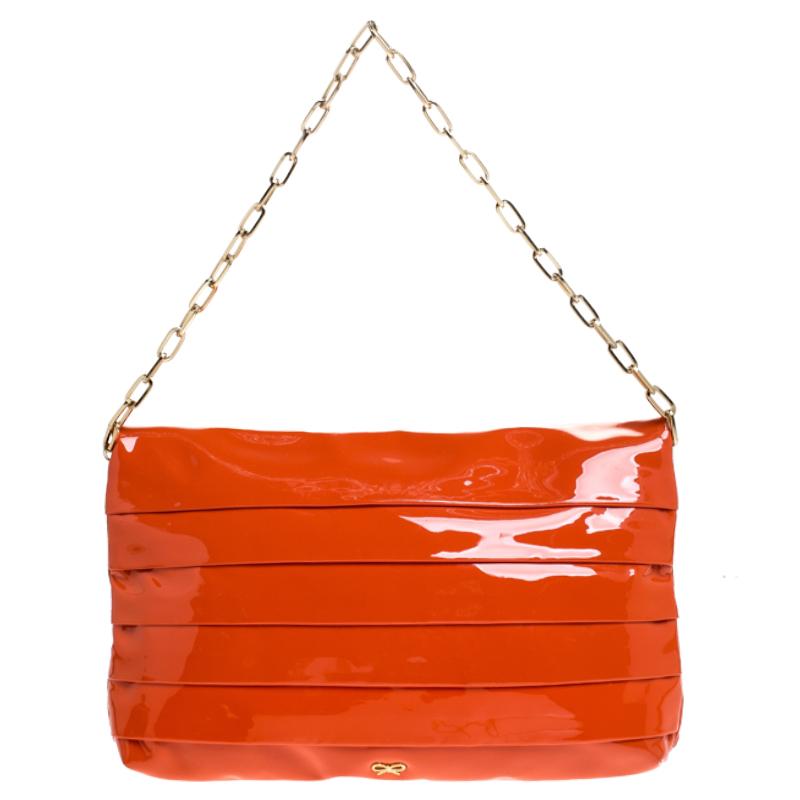 Comfortable and easy to carry, this patent leather bag is simply a must-have for your wardrobe upgrade. This well-designed bag can hold all your party essentials in its suede-lined interior. This magnificent handbag from Anya Hindmarch is all that