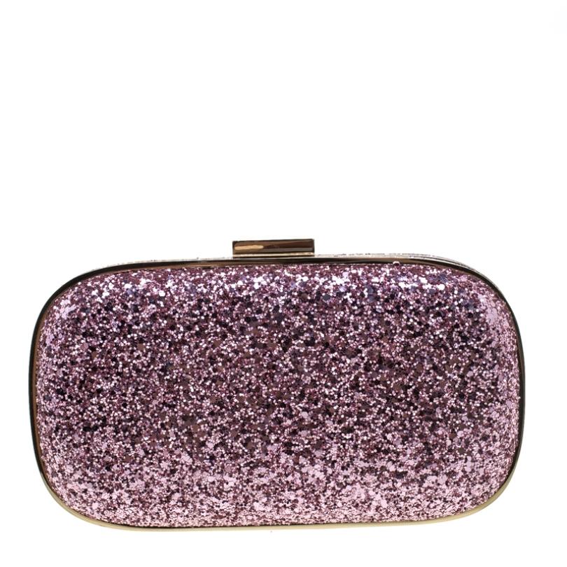 How breathtaking is this clutch by Anya Hindmarch! It is sparkly, well-crafted and overflowing with style. It has an exterior covered in pink glitter and a push clasp securing the suede interior. This creation will lift all your outfits with an