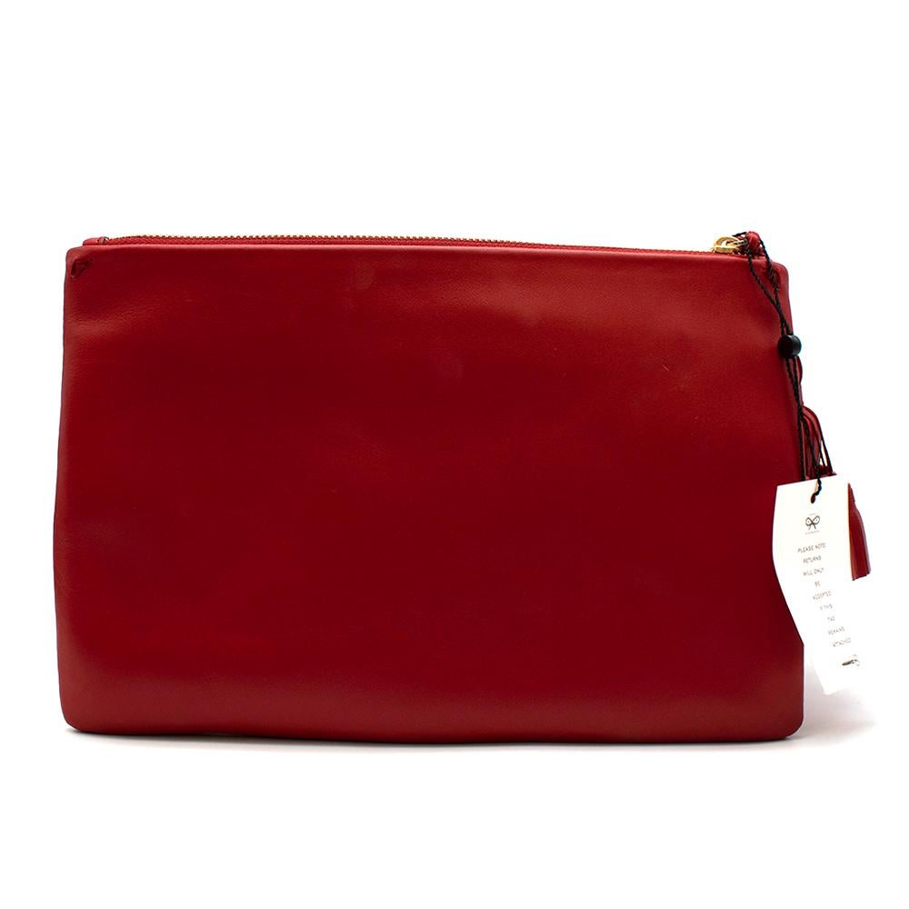 Anya Hindmarch Red Leather Georgiana 'Men At Work' Clutch Bag

- Red leather clutch 
- 'Men in Work' collection featuring graphic signage on front 
- Gold hardware zip fastening 
- Handmade leather oversized statement tassel 
- Grey suede interior