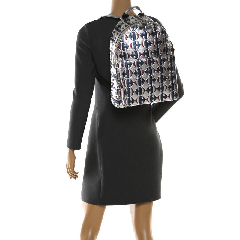 This Anya Hindmarch Carrefour backpack will come in handy for daily use or as a style statement. It is crafted from silver leather and designed with a Capra print all over, a front zip pocket and a spacious interior secured by a zipper. Two shoulder