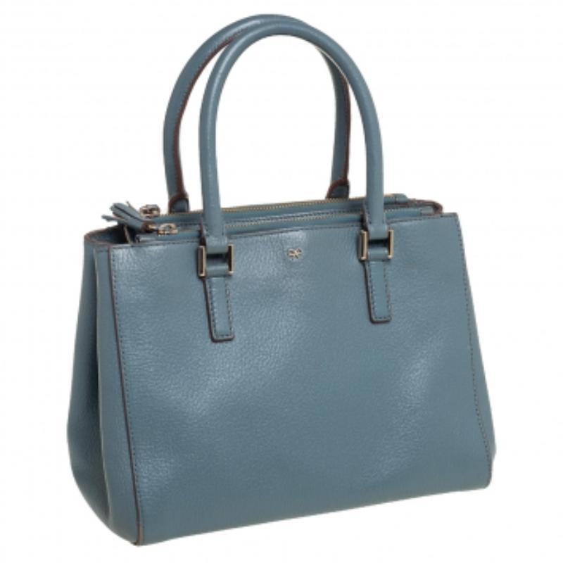 This Anya Hindmarch tote is both functional and stylish. From its design to its structure, the leather bag exudes charm and high fashion. It flaunts two handles for you to swing and a spacious fabric interior to hold all your essentials. This tote