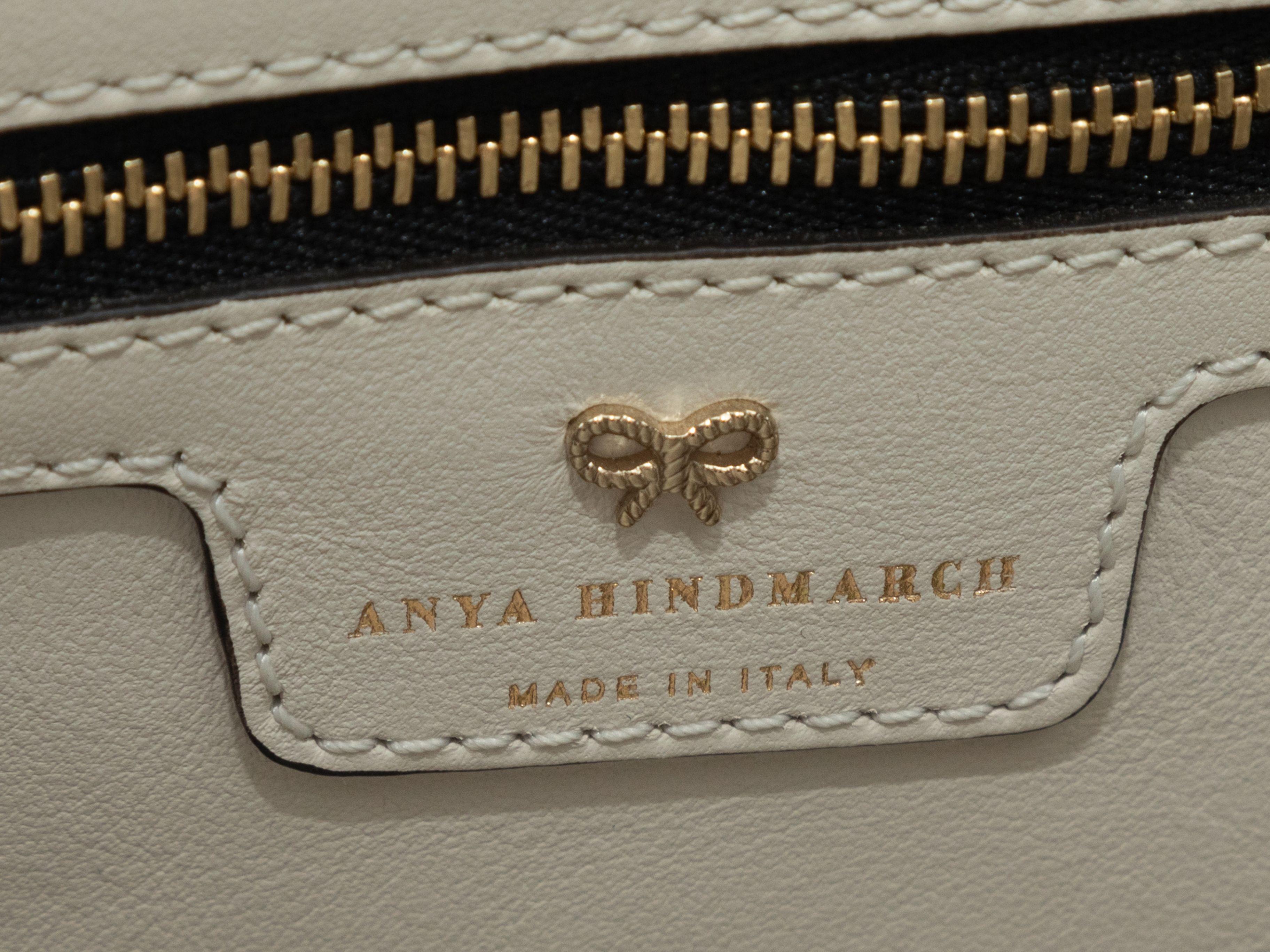 Product Details: White & Multicolor Anya Hindmarch Featherweight Allover Sticker Print Bag. This bag features an embossed leather body, gold-tone hardware, interior zip pocket, and dual rolled top handles. 13.5