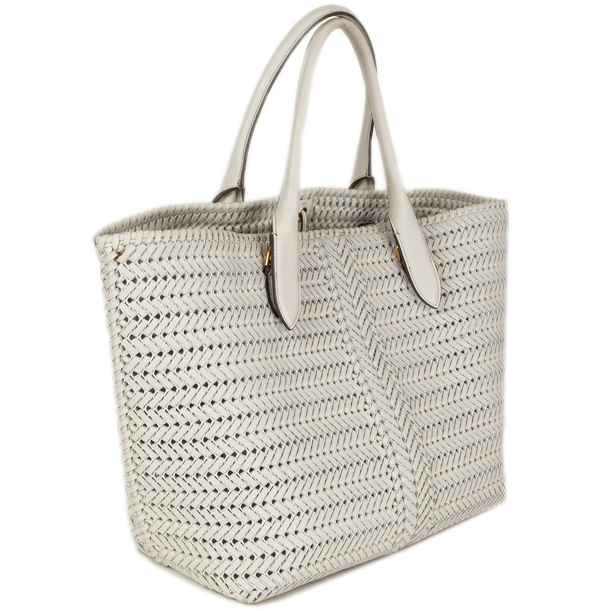 100% authentic Anya Hindmarch Neeson tote bag in chalk woven leather featuring signature bow logo detail at front. Ties at open top. Internal slip pocket with logo patch against the back. Has been carried with some very faint patina to the inside of