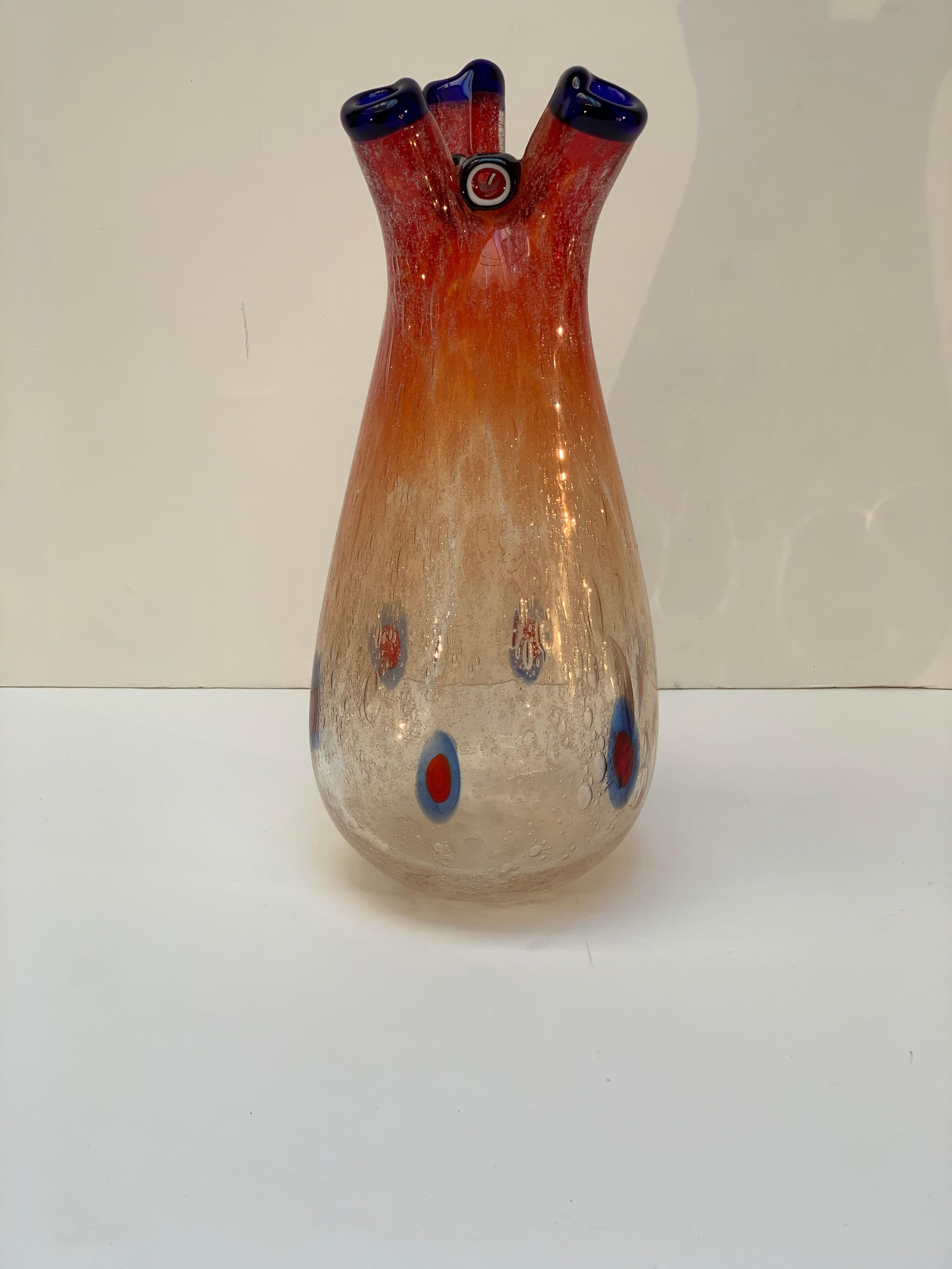 Blown Murano glass vase with three mouths edged with intense blue, body with air bubbles and Murrine coloring in the lower part, this series of vases called 