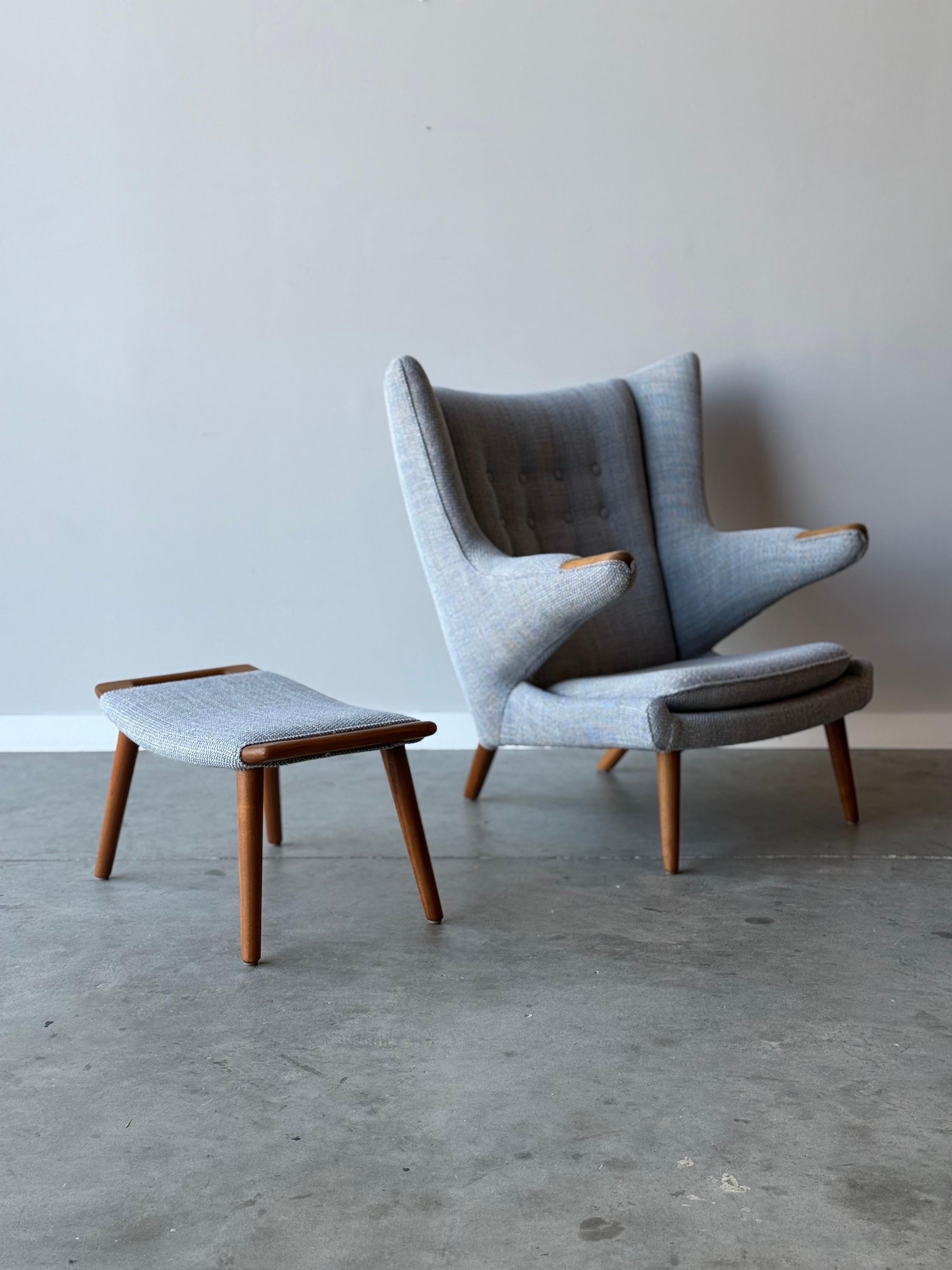 AP-19 Papa Bear Chair and ottoman designed by Hans J. Wegner and recently manufactured by Modernica. The Papa Bear Chair by Modernica is a beautifully crafted piece that blends comfort with timeless design. It’s a modern take on the iconic lounge