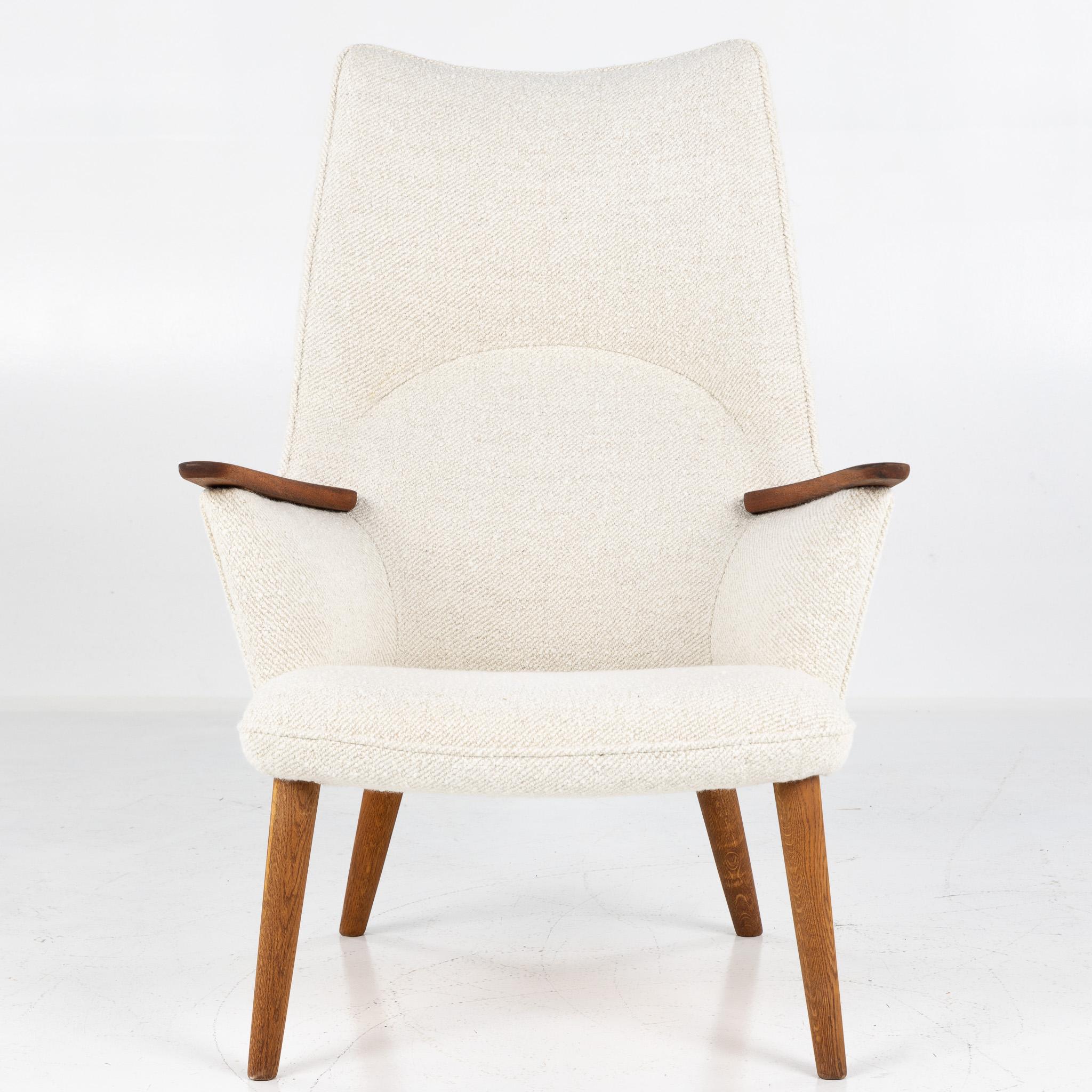 AP 27 - Lounge chair with teak armrests and oak legs. (Dedar A joy, 002 Natural). Designed in 1954 by Hans J. Wegner for AP Stolen.