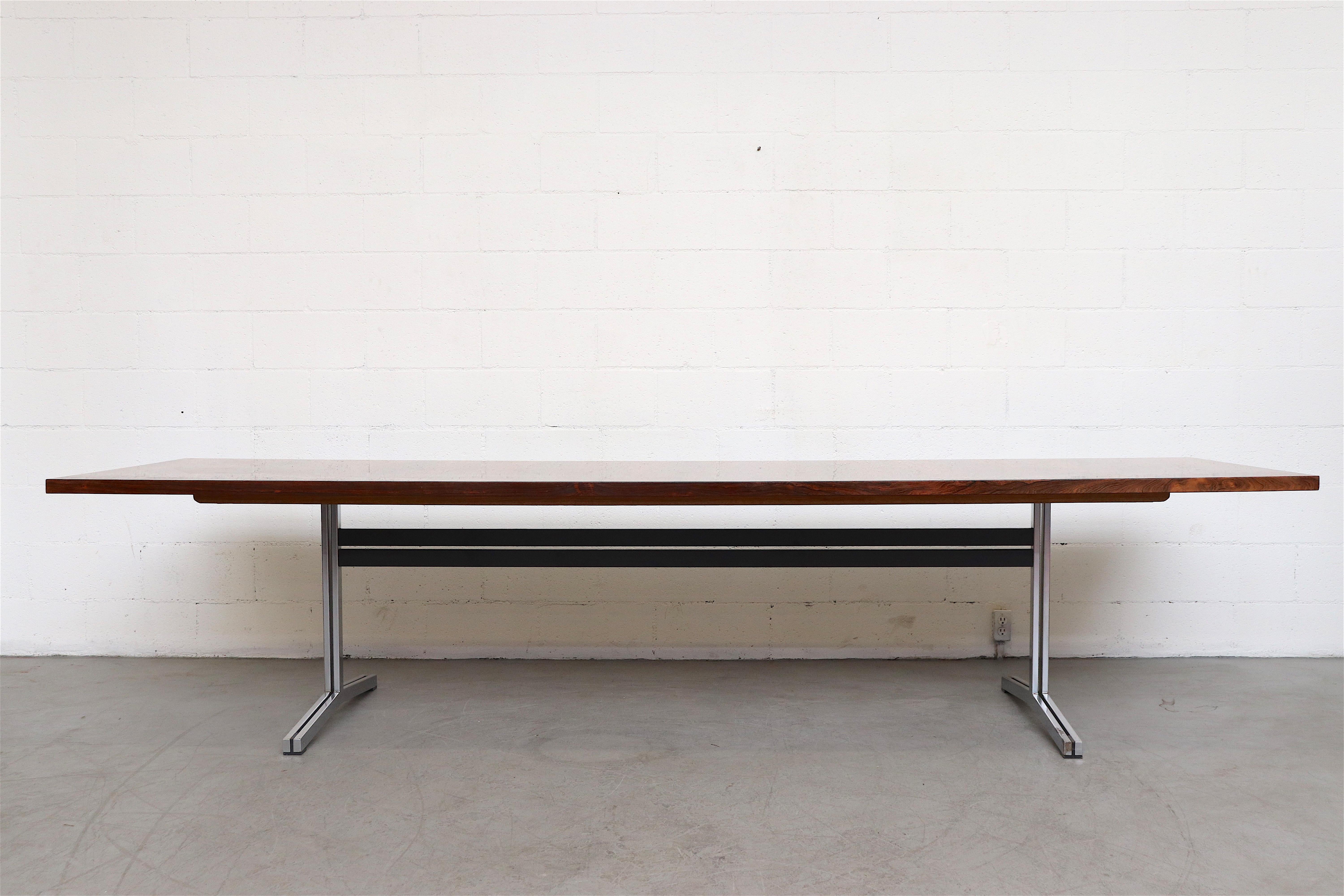 Gorgeous exceptionally long A.P. Originals rosewood dining or conference table with chrome and steel frame. Both top and frame are in very original condition. Frame shows some wear and some loss to the chrome. The top has a gloss lacquer finish with