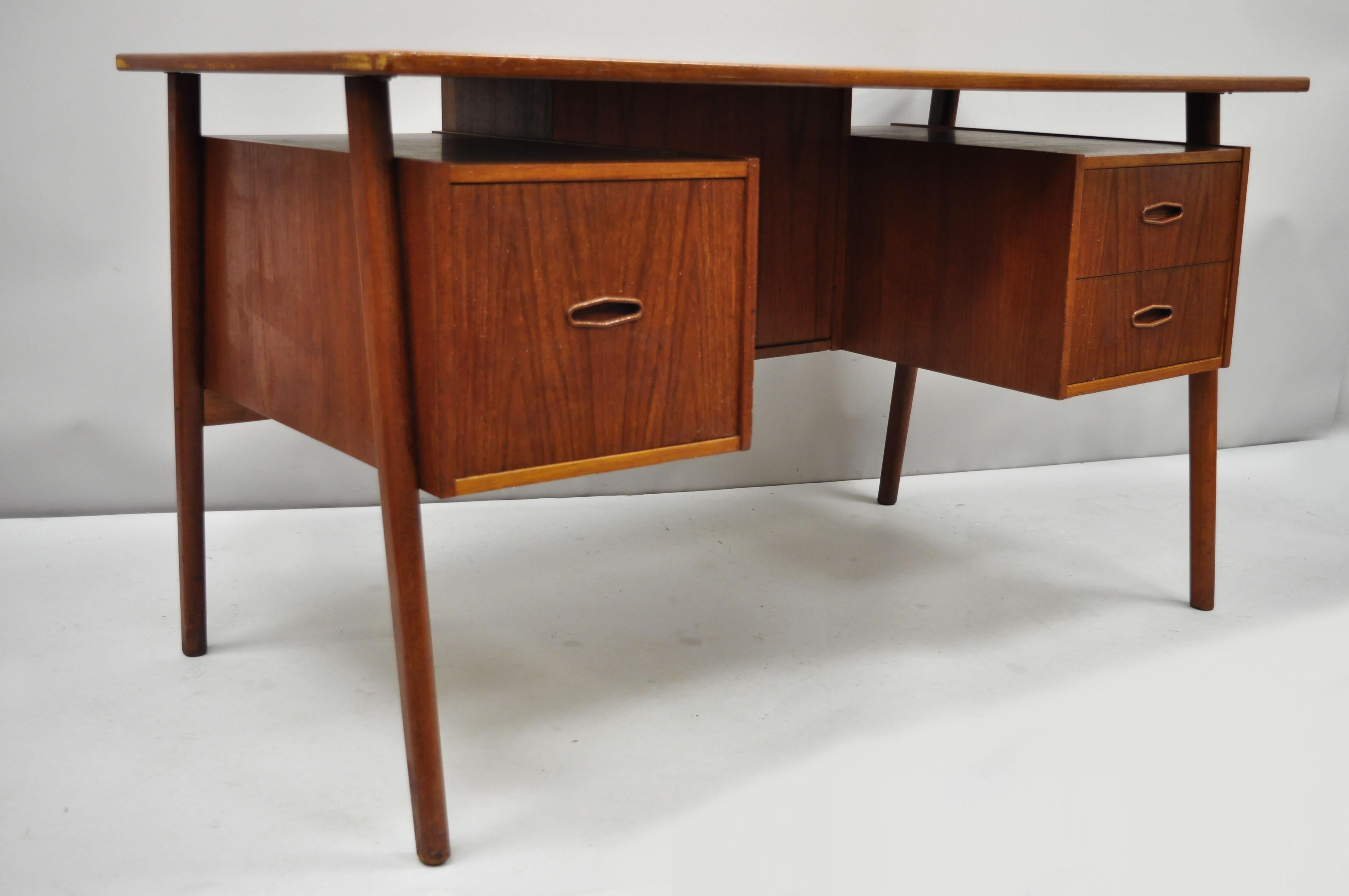 Vintage A.P. Svenstrup midcentury Danish modern teak floating form writing desk. Item features drop down rear compartment (currently locked), sleek 