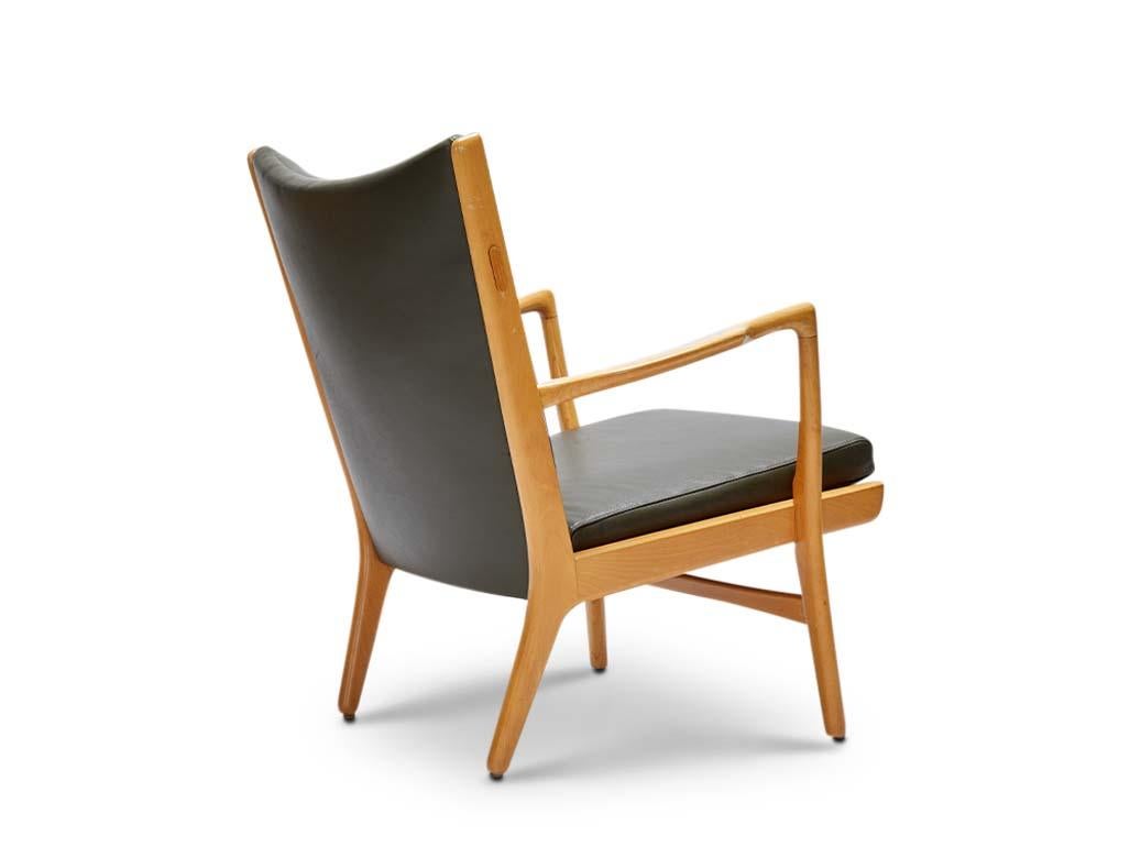 AP16 Armchair by Hans Wegner. Beech frame with an olive leather cushion. Manufactured by AP Stolen, Copenhagen. 