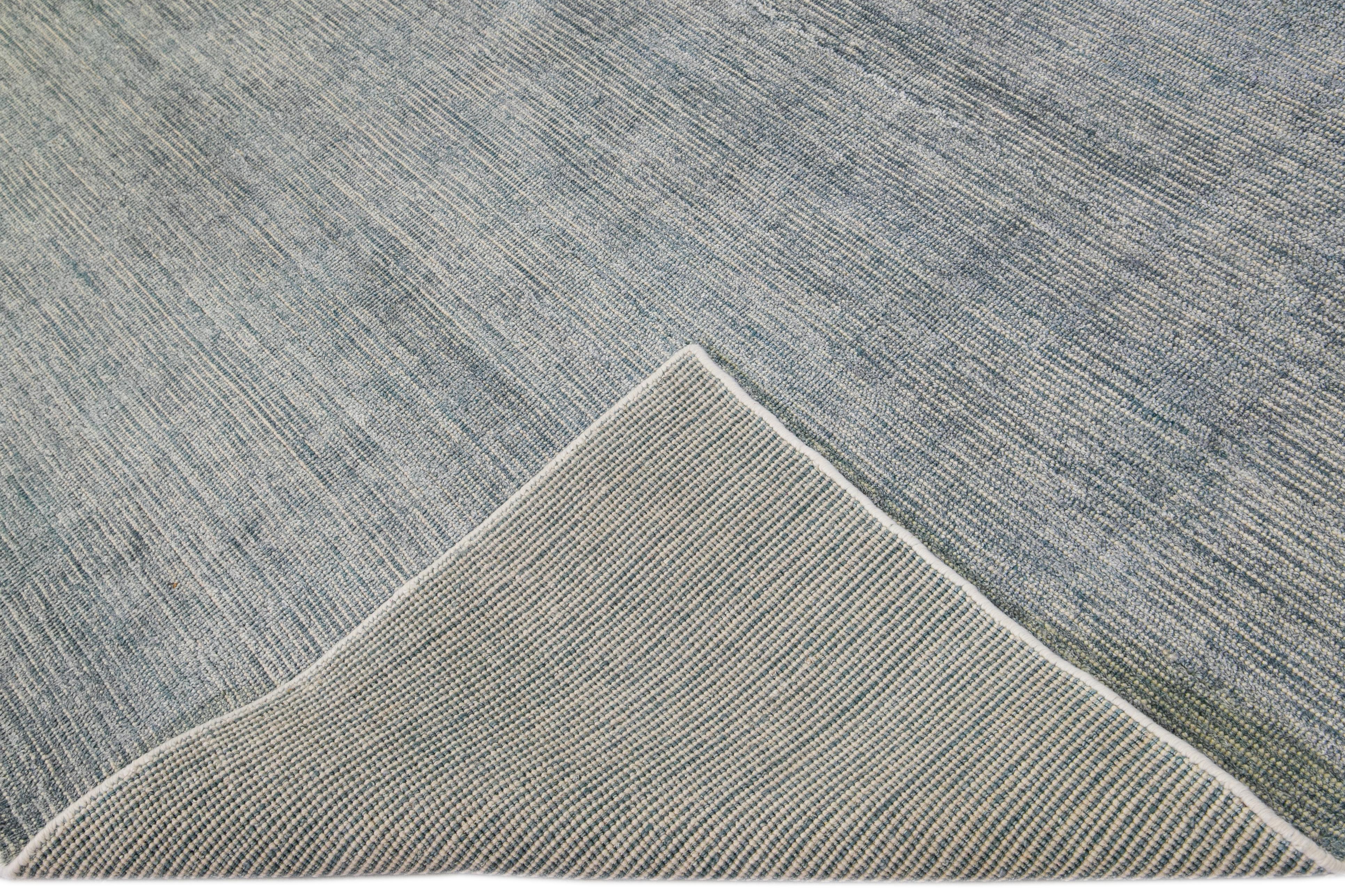 Beautiful modern handmade Indian bamboo and silk Groove rug with a blue and gray field. This Boho collection rug has an all-over solid design.

This rug measures: 8' x 10'.

Custom colors and sizes are available upon request.

