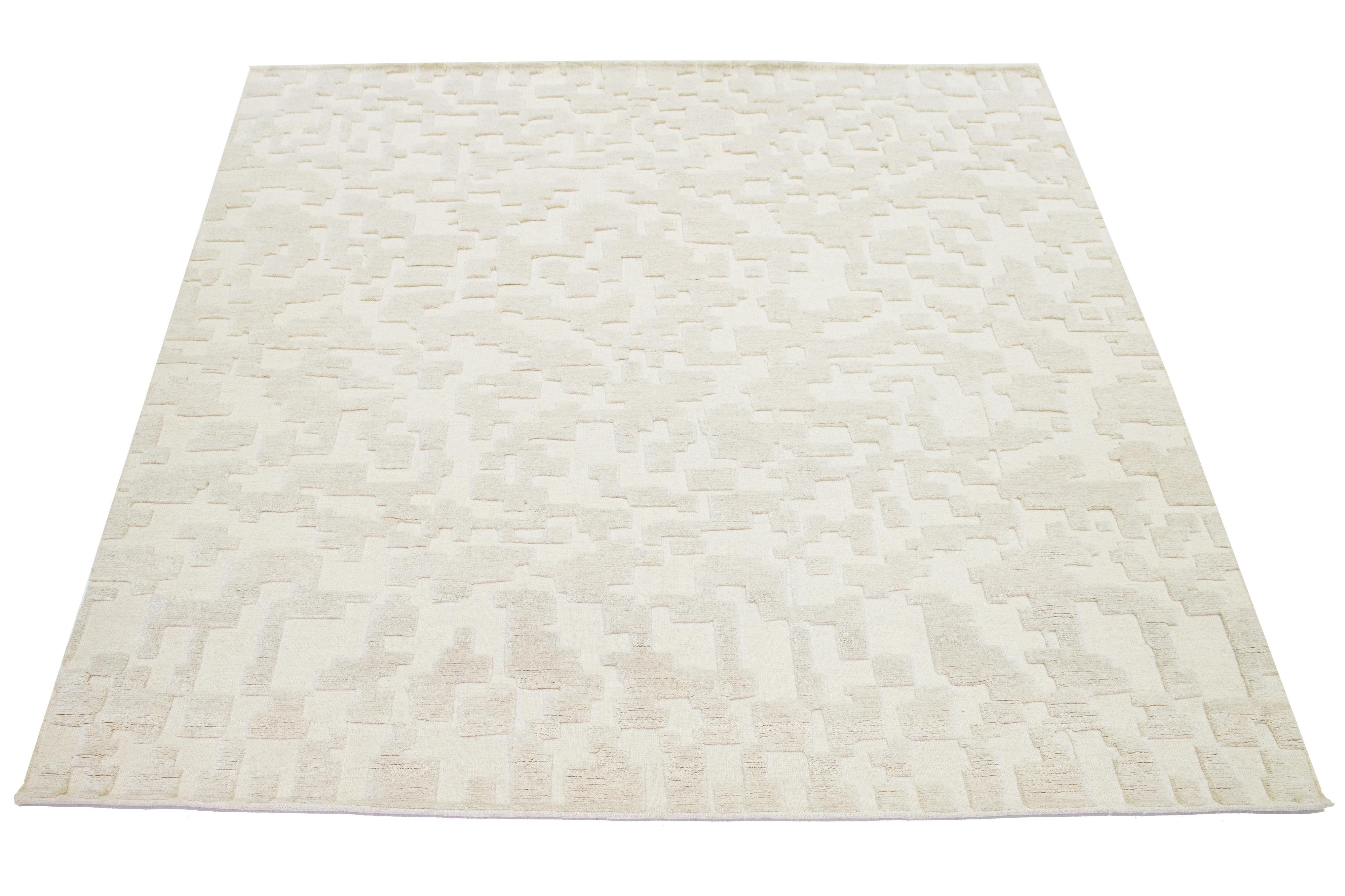 This hand-knotted Moroccan-style wool rug showcases a mesmerizing minimalist aesthetic on a natural ivory field with a contemporary abstract design.

This rug measures 8'2